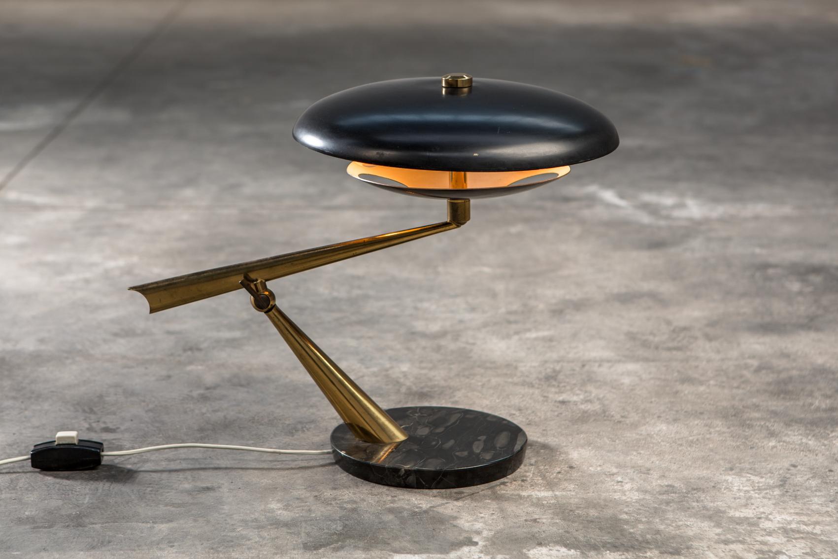 A rare desk/table lamp made by Lumen in Italy in the 1950s. Black marble base, brass frame and varnished aluminium. In good working vintage condition. H: 45 cm
Ships worldwide.