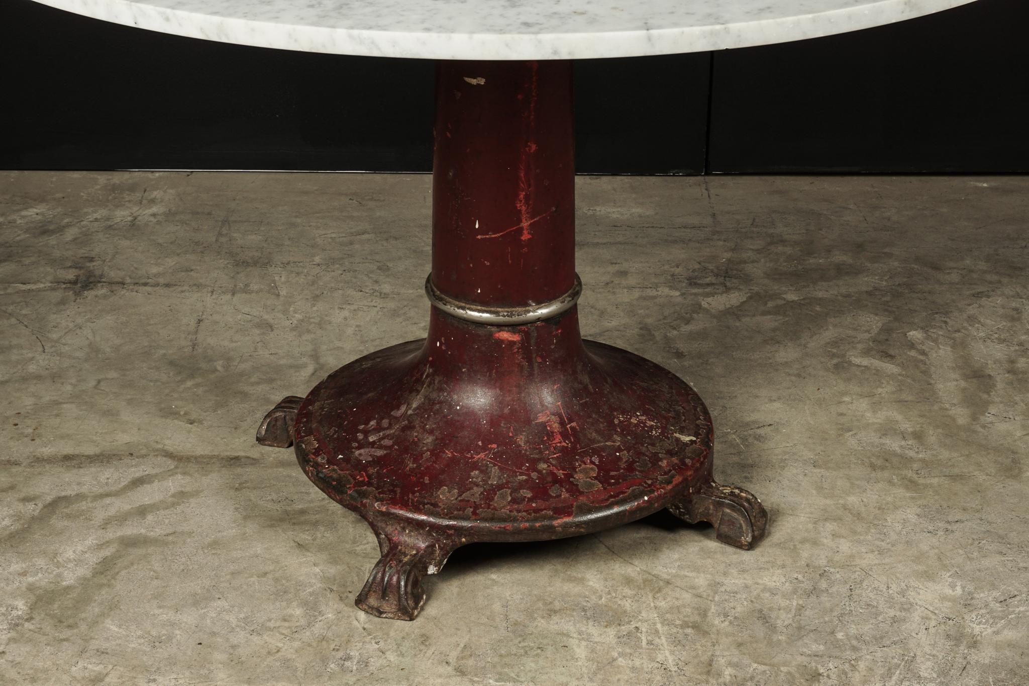 Rare marble dining table with iron base, circa 1920. Base with original fantastic original color. Later marble.