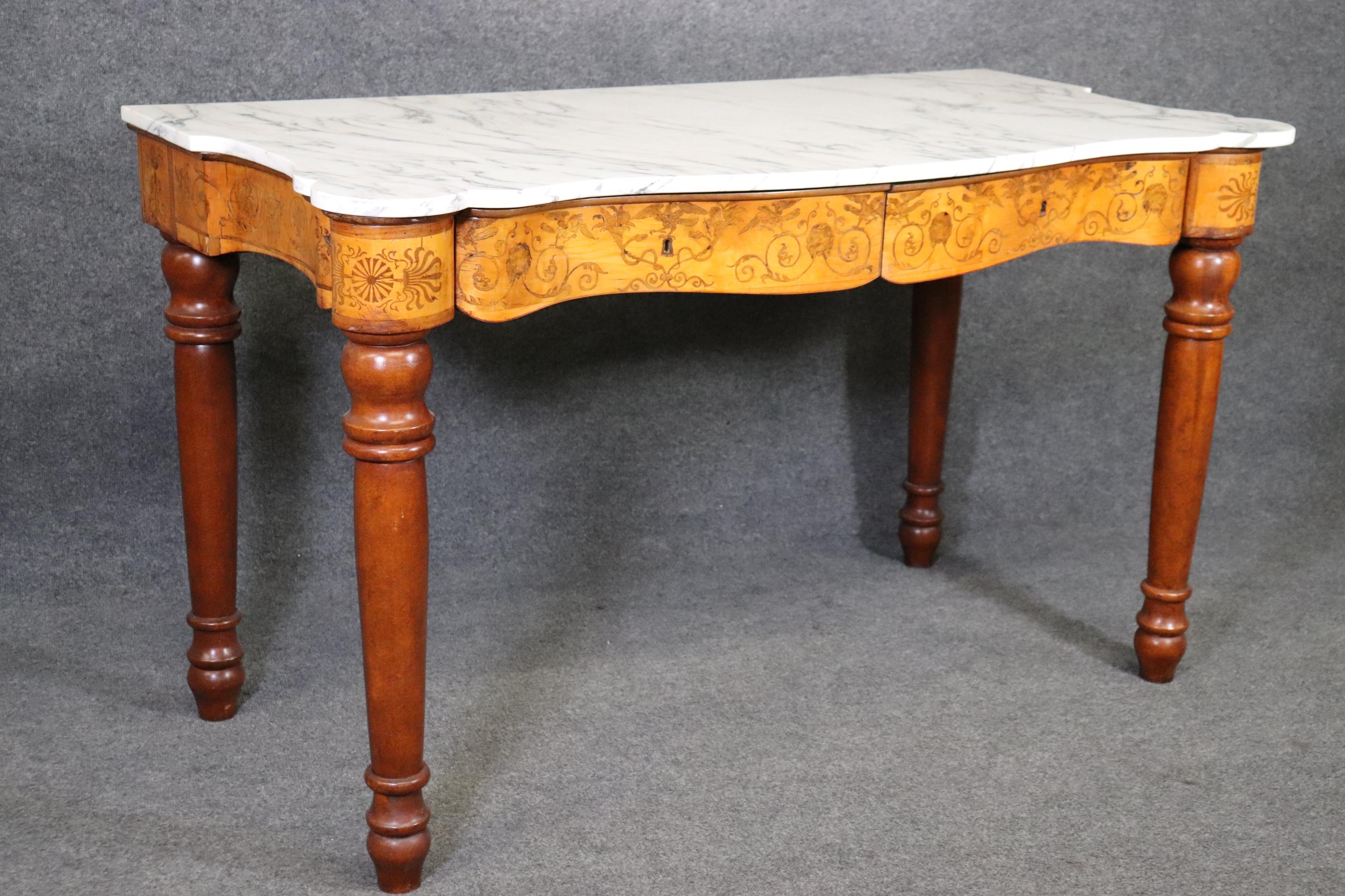 This is a very rare marble top pastry or pasta table made in Italy in the middle to later part of the 1800s. The table can be used as a desk or even as a kitchen island or serving table. perhaps as a console table. The table is in good condition