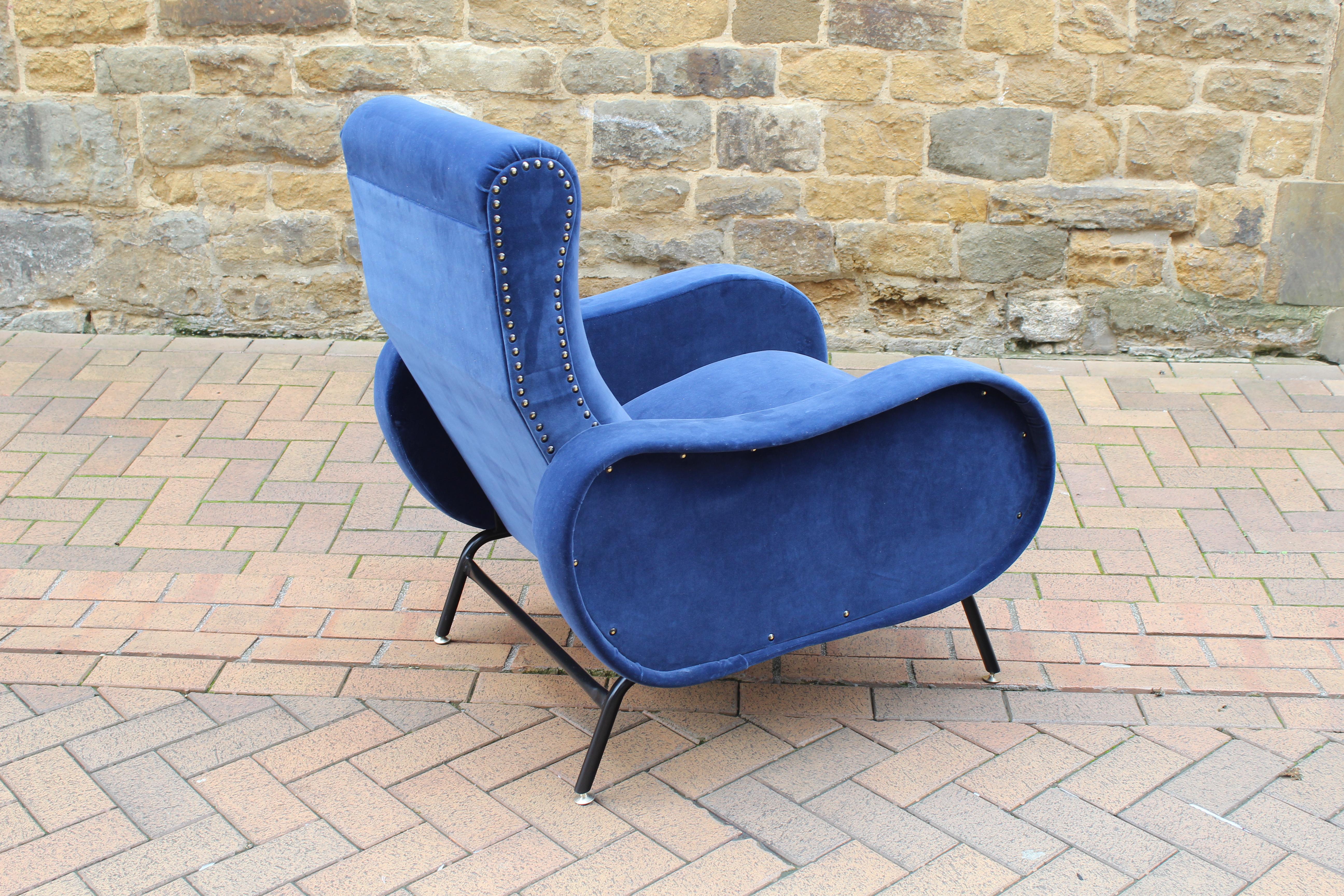 A beautiful 1950s Italian reclining armchair attributed to Marco Zanuso in a high quality deep blue velvet upholstery.

The chair sits on metal legs and smoothly reclines when you lean back into the chair, one of the most comfortable chairs you