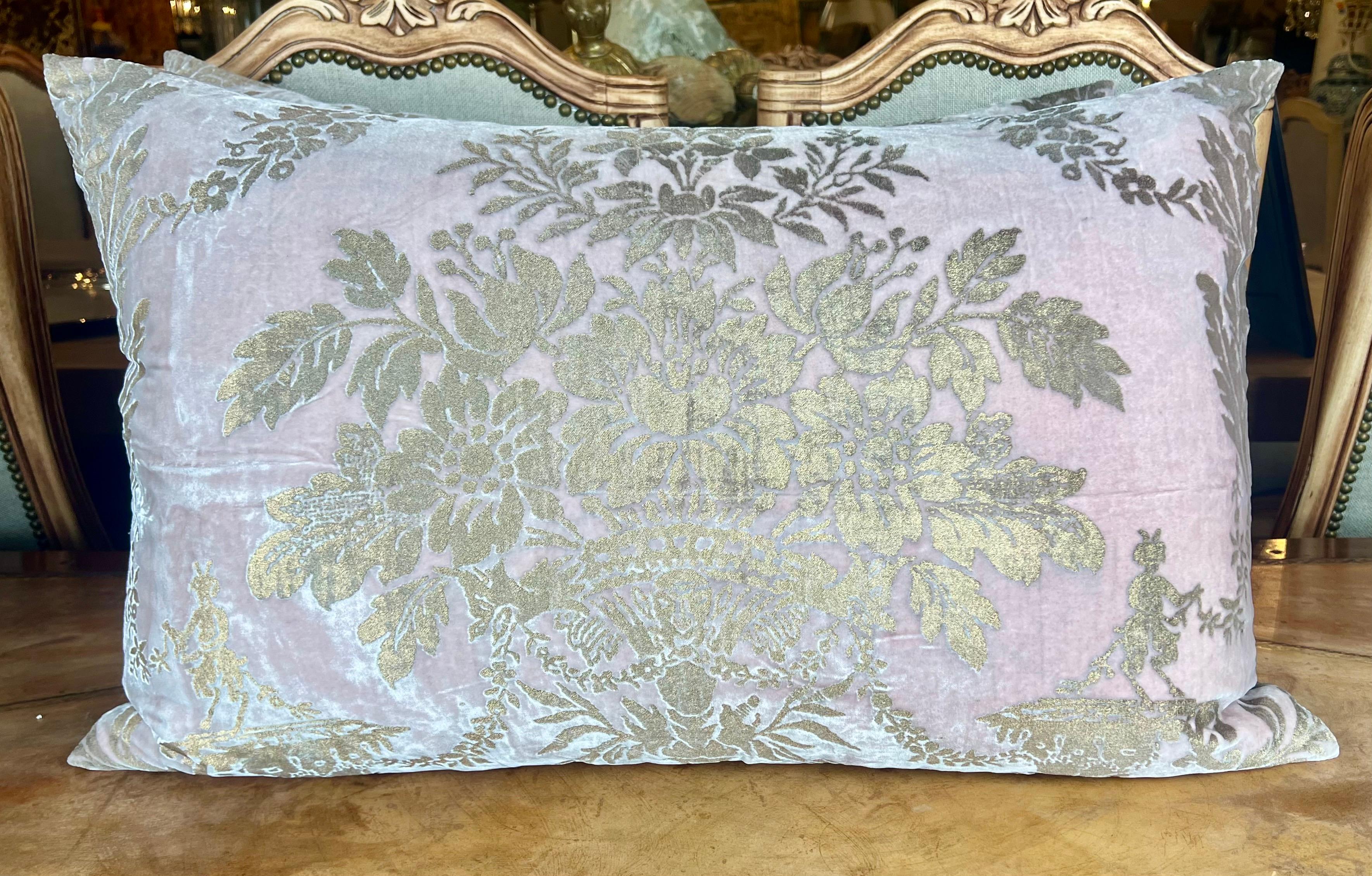 Beautiful pair of pillows made with rare Mariano Fortuny velvet. They feature a metallic gold bouquet of flowers in the center on a soft pink velvet background. There are coordinating silk backs and down filled inserts combining both elegance and