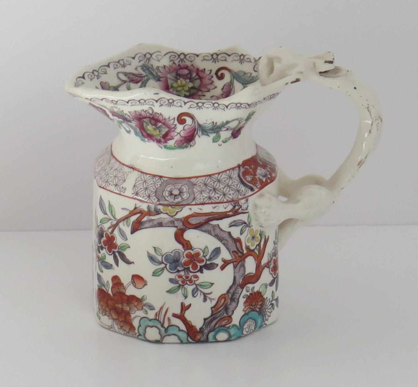 This is a good ironstone pottery jug or pitcher made by Mason's, of Lane Delph, Staffordshire, England, circa 1840. The shape, pattern and base markings are all rare. 

This jug has the rarer hexagonal Fenton shape with a dragon loop handle. The