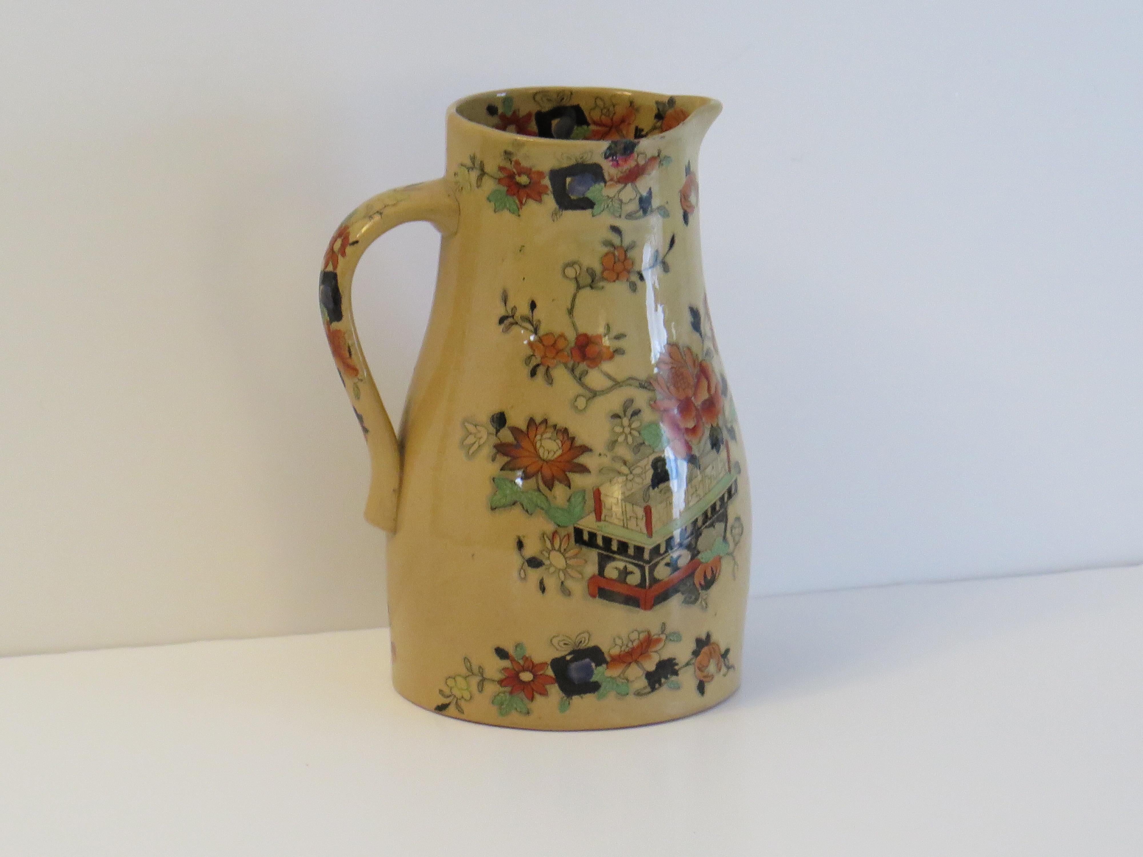 This is a fairly large jug or pitcher by Mason's Ironstone pottery in the flower box pattern all dating to the mid-19th century, circa 1830-1851 Victorian period.

This Mason's jug has a rare shape and pattern, with a beautiful ochre glaze with