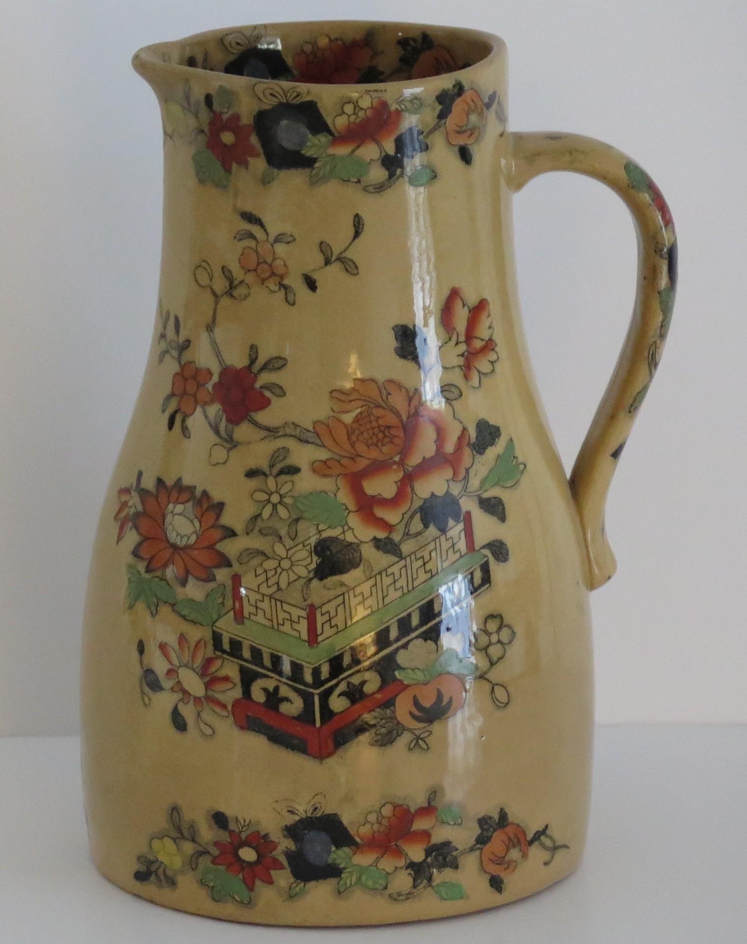 This is large jug or pitcher by Mason's Ironstone pottery in the flower box pattern all dating to the mid-19th century, circa 1830-1851 Victorian period.

This Mason's jug has a rare shape and pattern, with a beautiful ochre glaze with beautiful