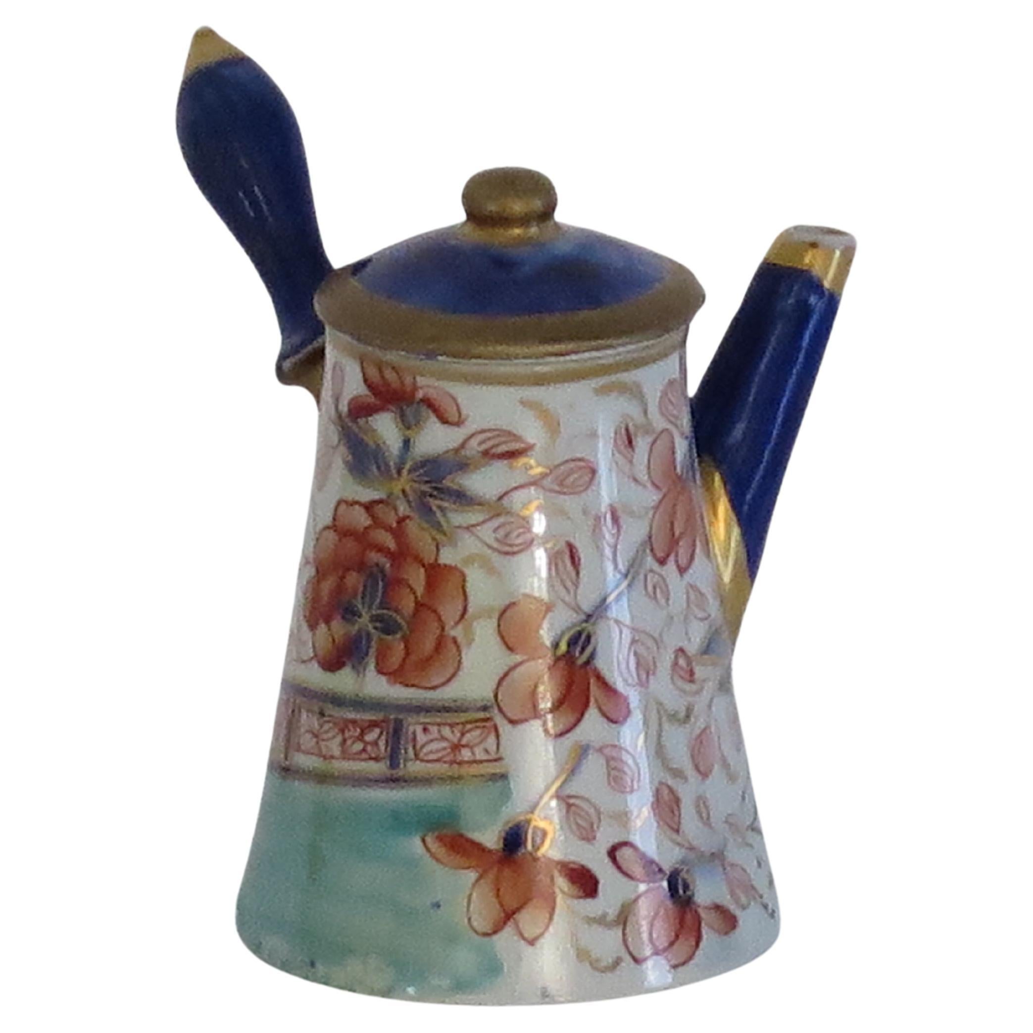 This is a very rare Mason's ironstone miniature Coffee Pot in the Gold Rose Japan gilded pattern, which we date to circa 1820.

Miniature or toy items of Masons ironstone are hard to find today.

This piece is well potted as a Coffeepot with a