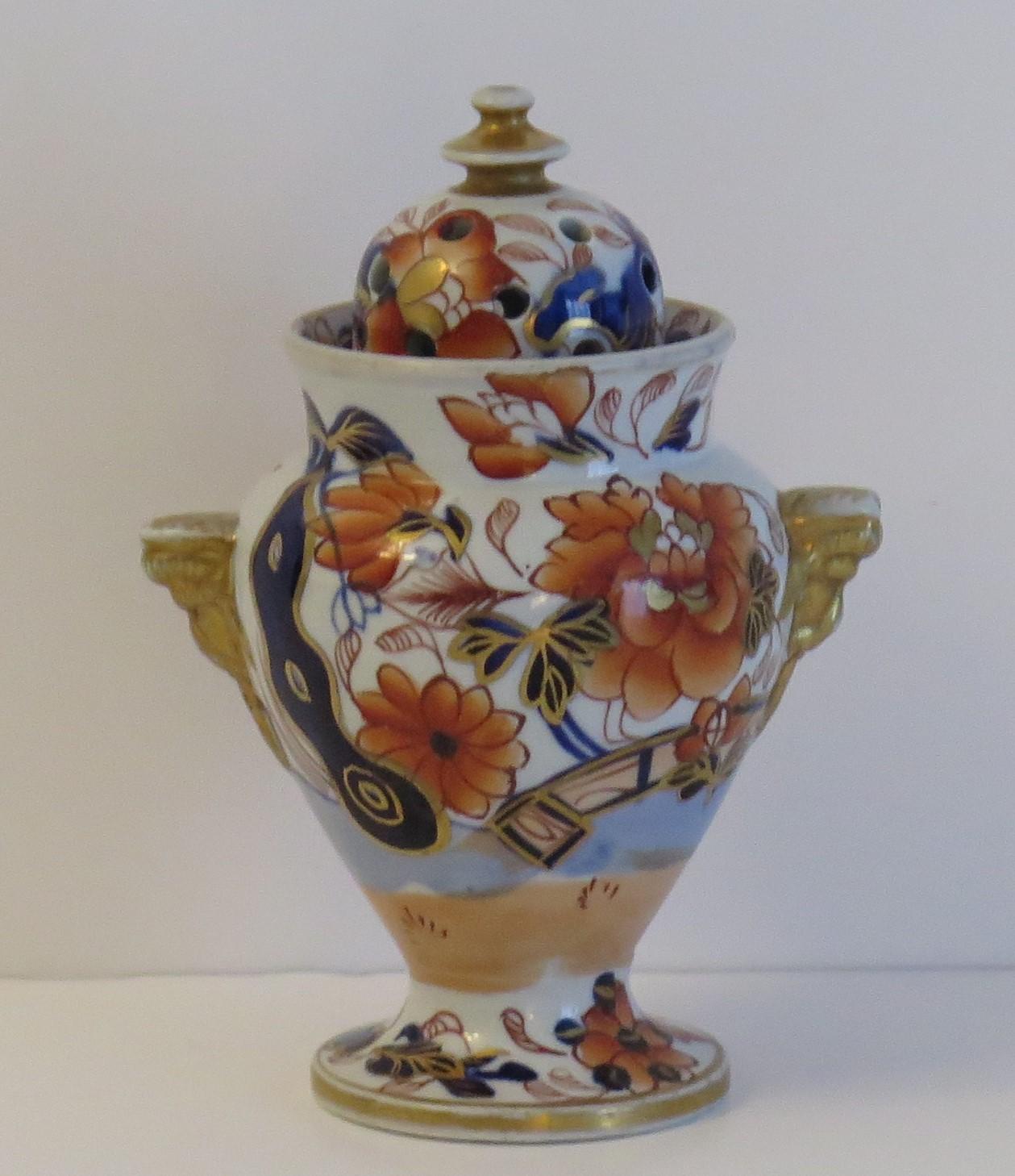 This is a rare shaped ironstone lidded vase, forming a Pot Pourri vase, in the gilded and hand painted Fence Japan pattern, made by the Mason's factory in the early 19th century, circa 1817.

The vase has a good baluster profile, with two mask