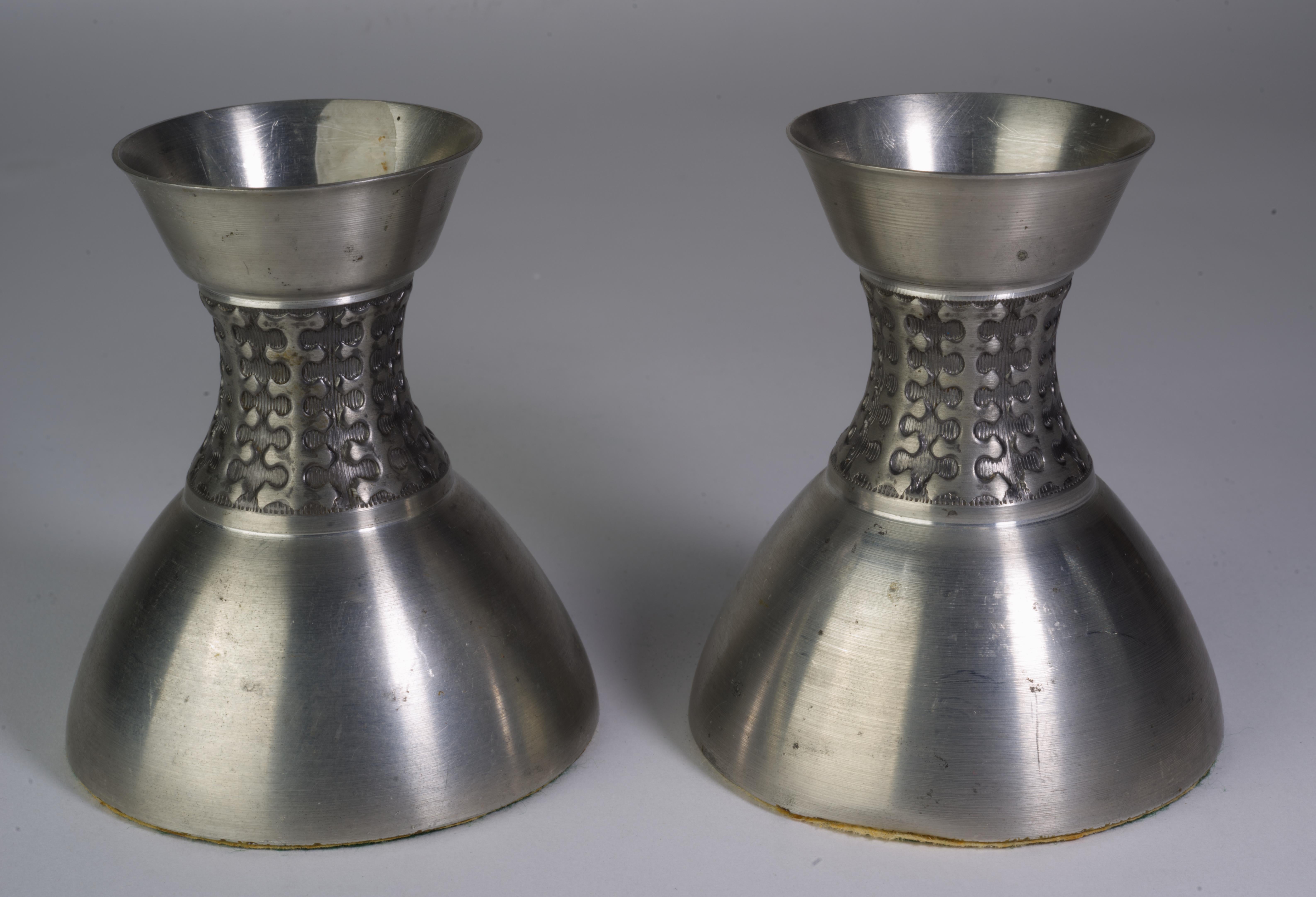  Rare pair of pewter candle holders in Scandinavian Midcentury Modern style was made by Mastad Norway in 1950s. Each candle holder has built-in bobeche to prevent wax drippage, weighted base, and felt pad on the bottom. They are signed with