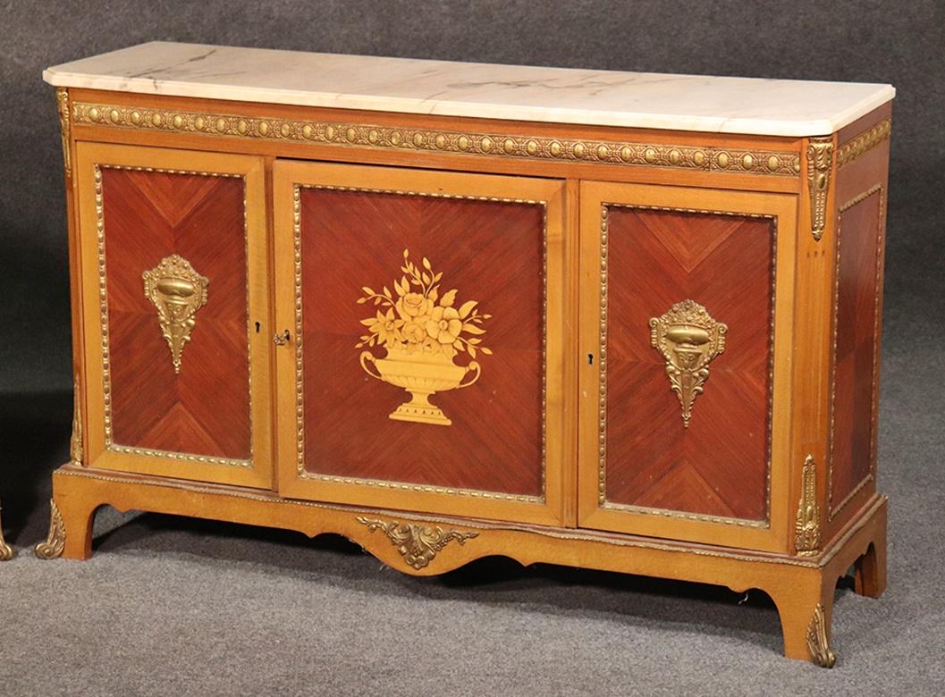 These are rare and hard to find in matched pairs. These French satinwood and rosewood marble-top sideboards have 3 doors that contain 1 shelf.