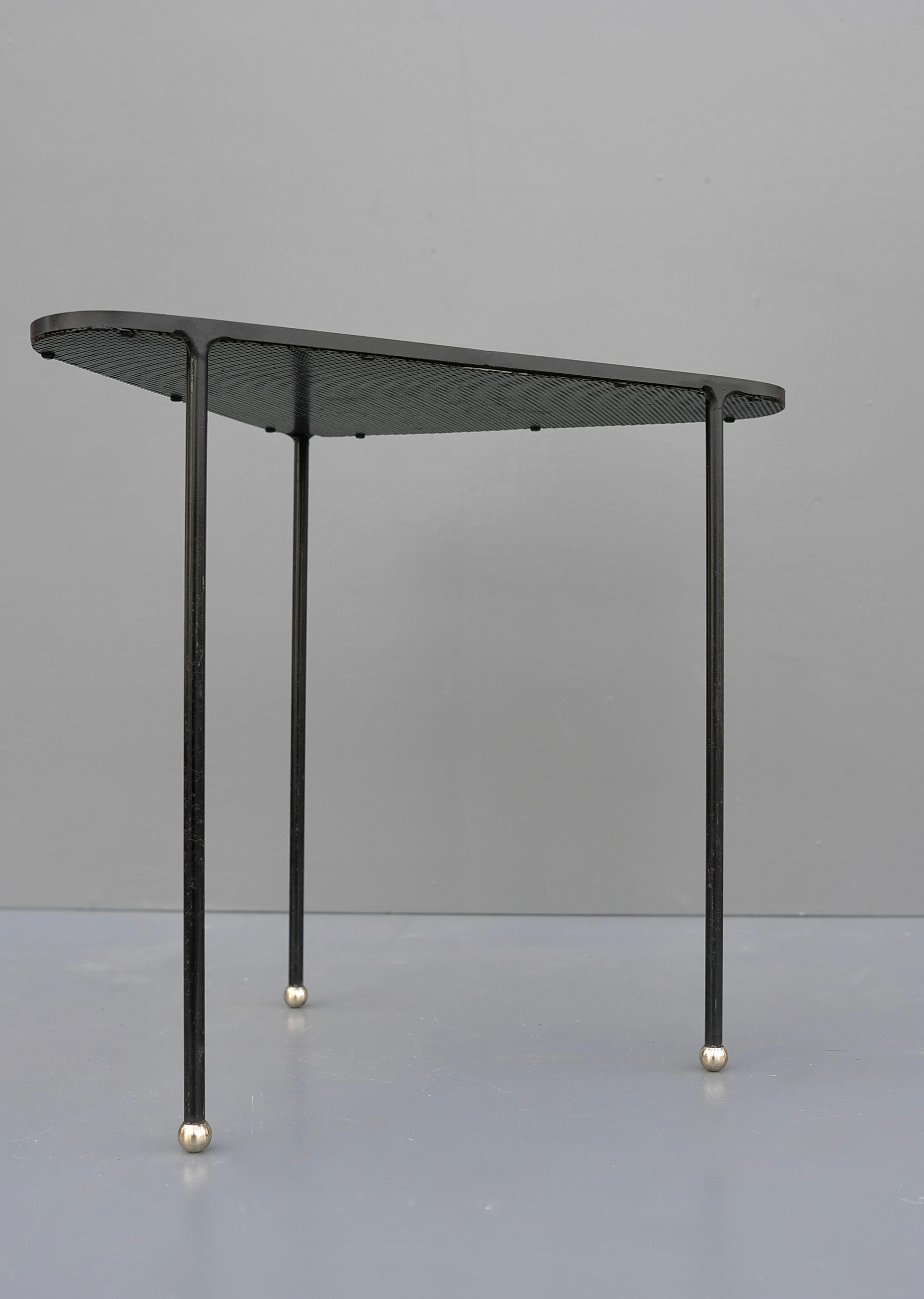 Mathieu Matégot 'Orleans' black metal and brass, side table, France, 1955.