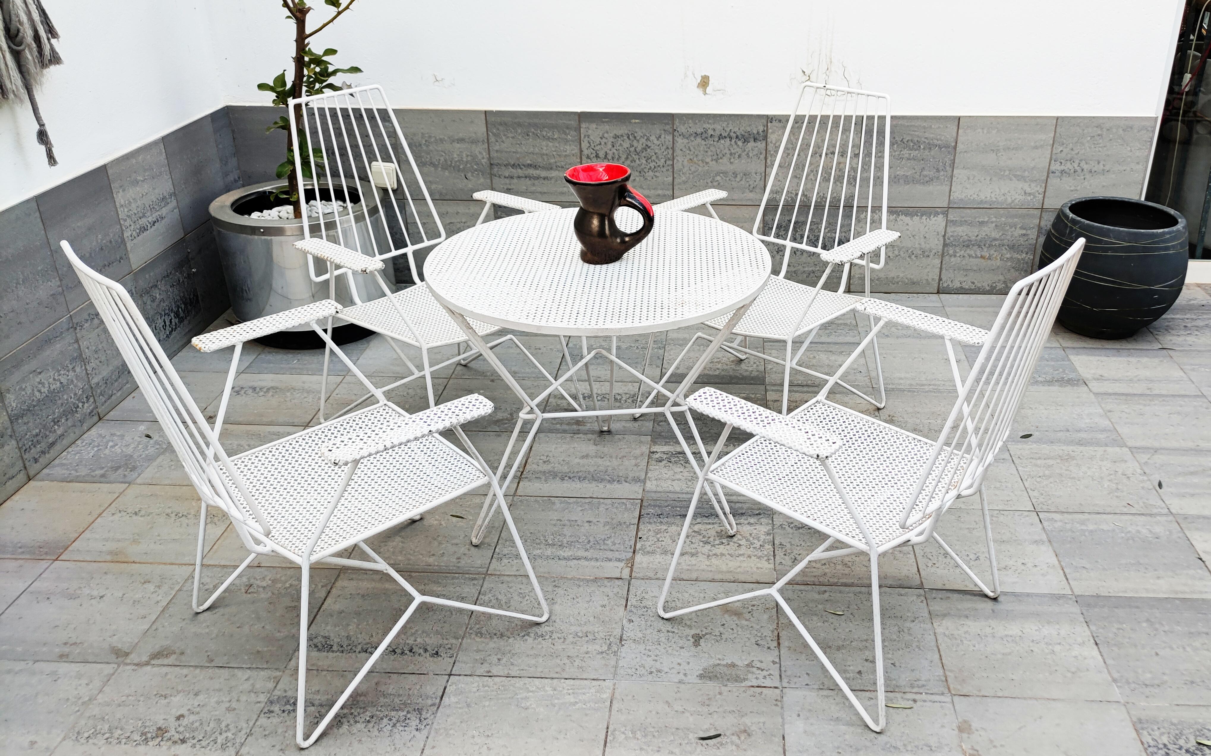 Beautiful and rare Mathieu Matégot set of iron low armchairs and table manufactured in France in 1950s. In perfect vintage condition. 4 armchairs and 1 table.
Dimensions (cm) :
Table : 71d x 60h
Armchairs (4): 61w x 58d x 81h , Seat hight : 32h.