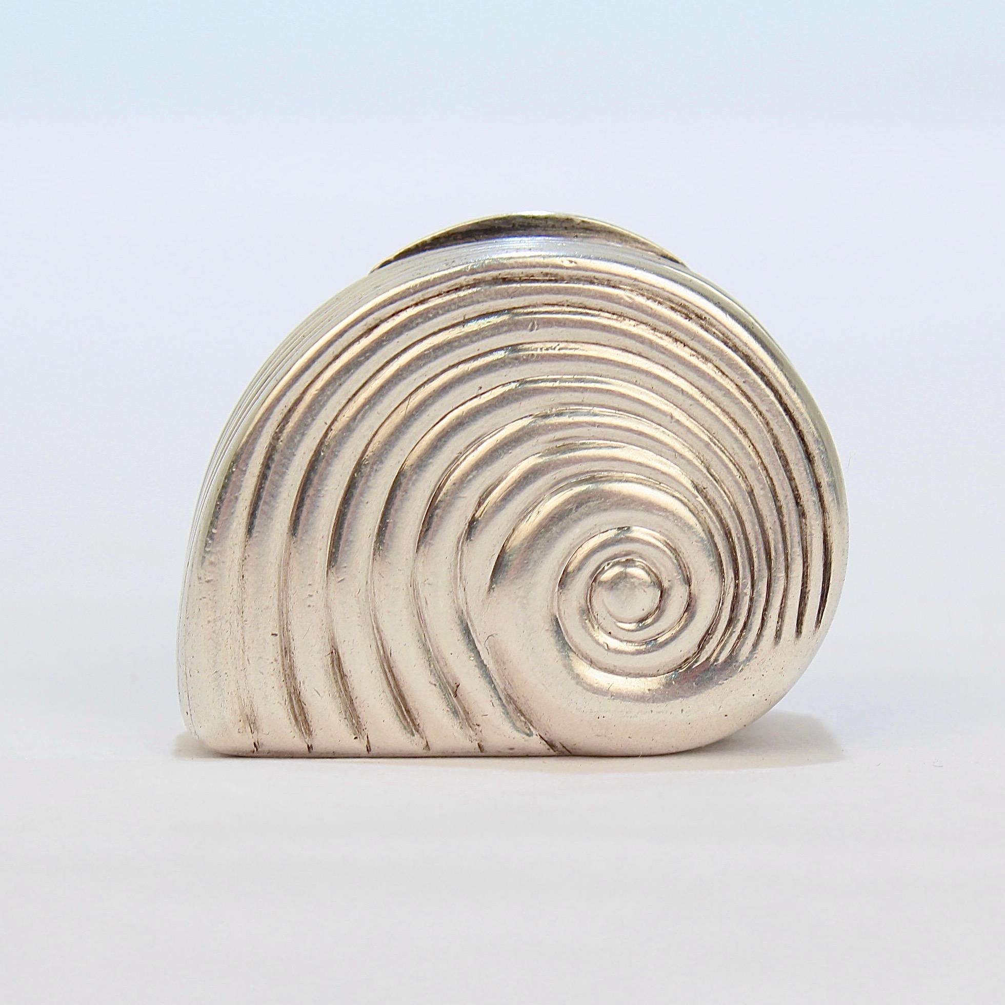 A very fine rare Georgian English sterling silver vinaigrette.

In the rare figural vinaigrette form of a snail shell or sea shell. 

It was made by Matthew Linwood II - a Georgian Birmingham silversmith with a noted specialty in boxes.

This piece