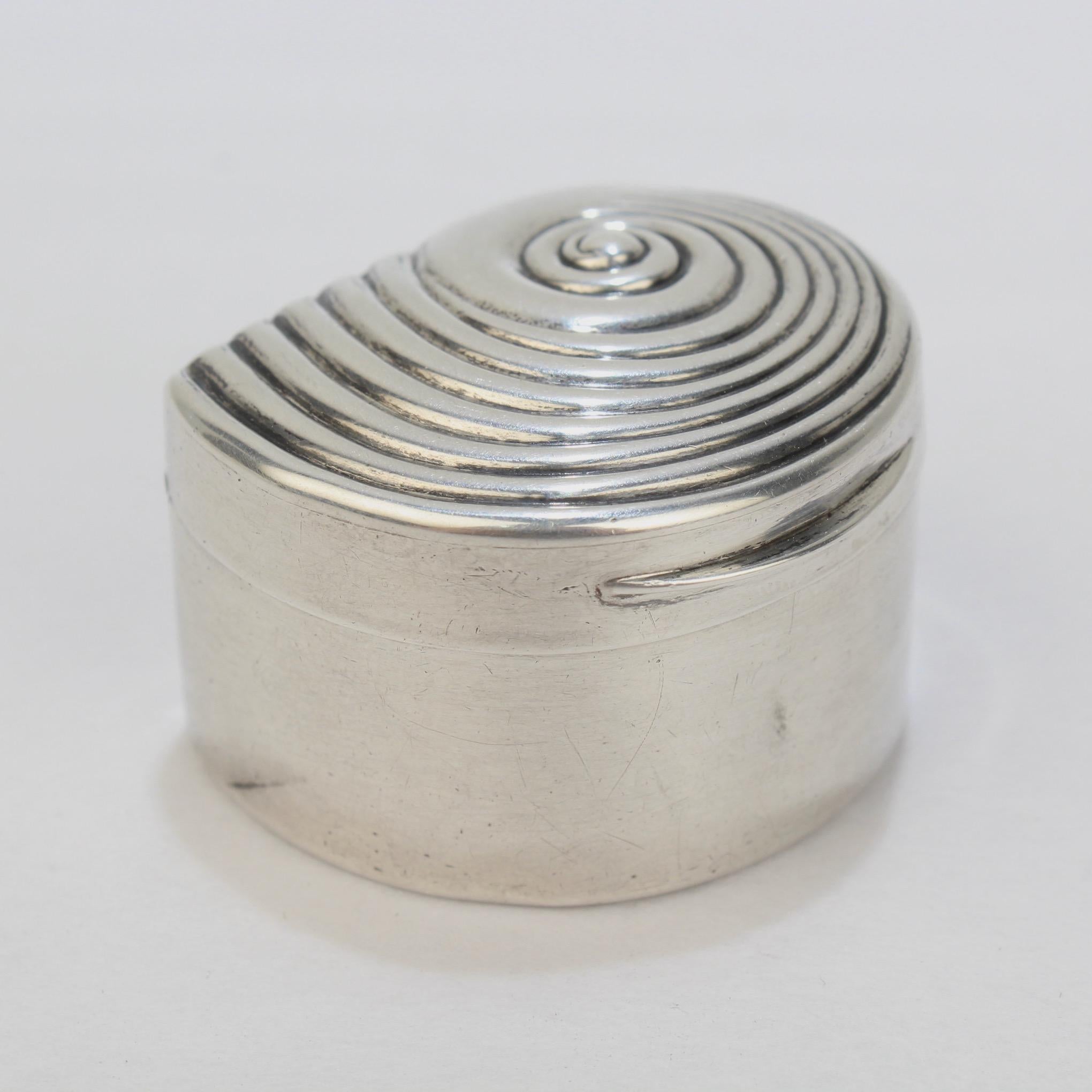 A fine and rare antique English Georgian sterling silver box.

In the rare figural form of a snail shell or seashell. The interior of the box is gilt.

It was made by Matthew Linwood II, who was a very fine Birmingham silversmith with a noted
