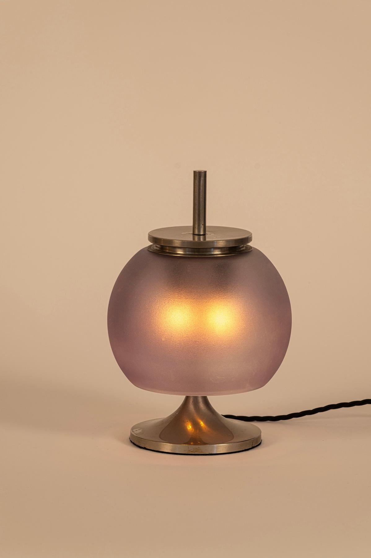 Chic table lamp by Emma Gismondi Schweinberger.

Nickelled  brass and blown glass

The blown glass shade is a lovely shade of mauve

Takes 2 x ES bulbs

