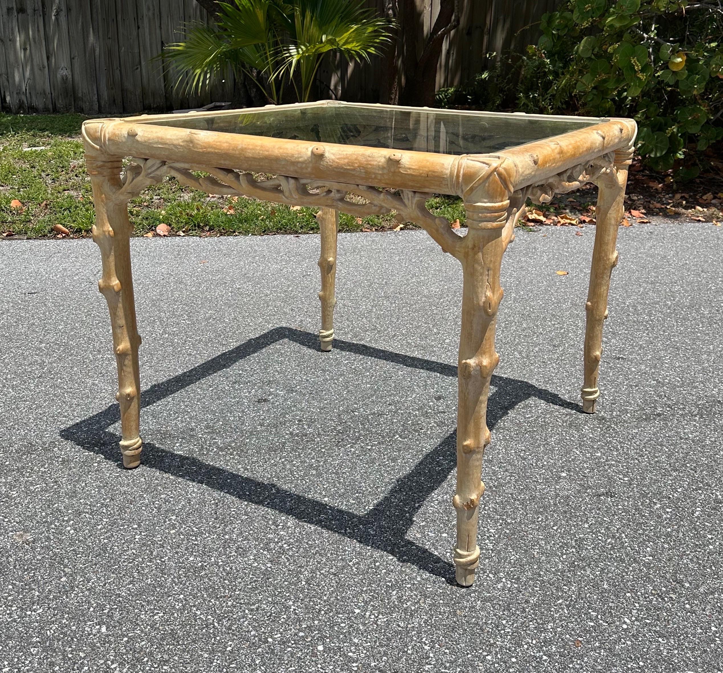 Rare faux twig glass top game table made by McGuire part of the Nancy Reagan Architectural Digest collection. Very well made detailed carved wood. Inset glass. This faux bois style is very versatile and can be paired with many different types of