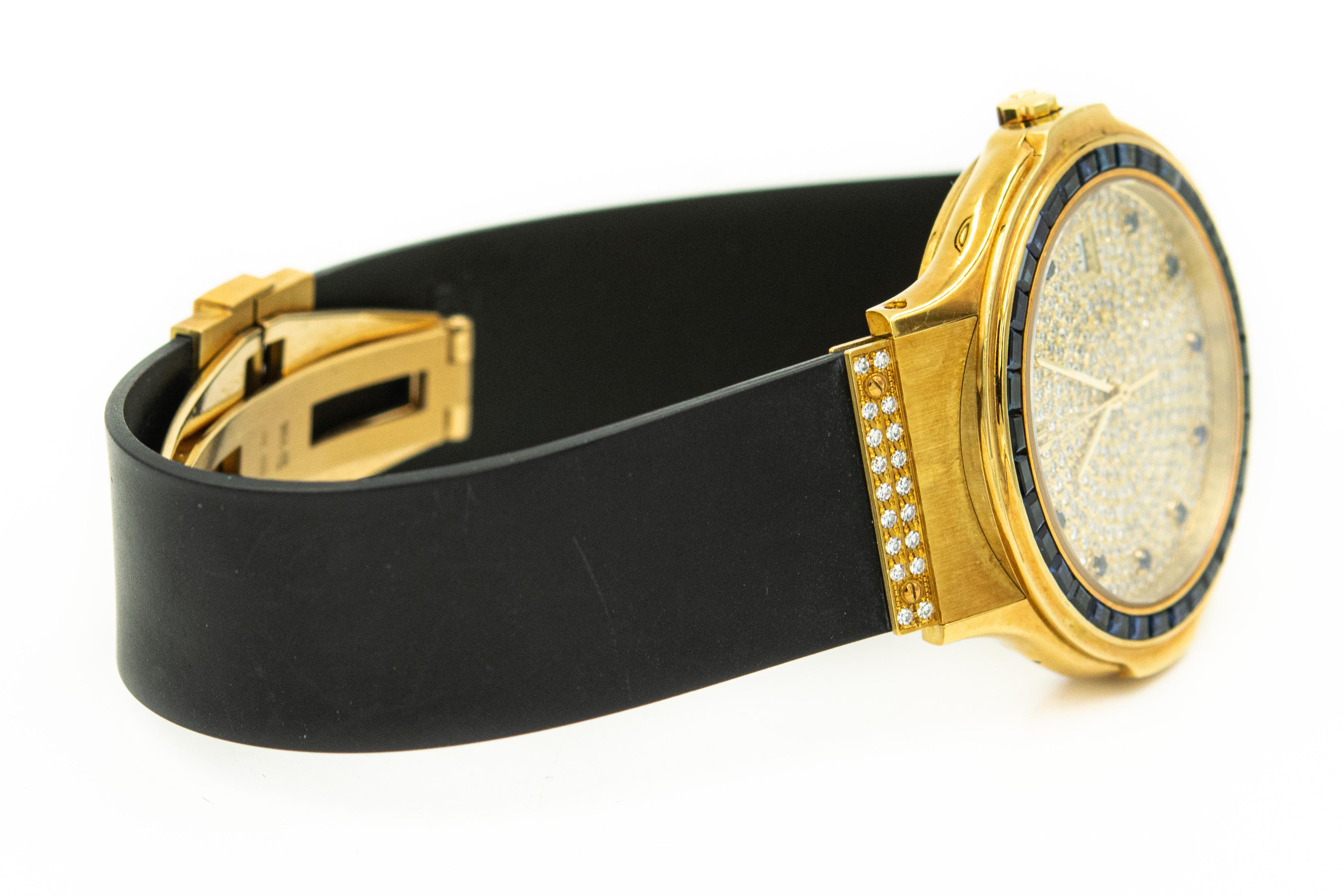 Men's Hublot Wristwatch with Sapphire Bezel and Indexes Ref. 1522.3.081 Serial 282623 features a 37 mm x 44mm 18k yellow gold case, with a pave set diamond dial on a black rubber strap and factory-set diamond buckle. It has a distinctive sapphire