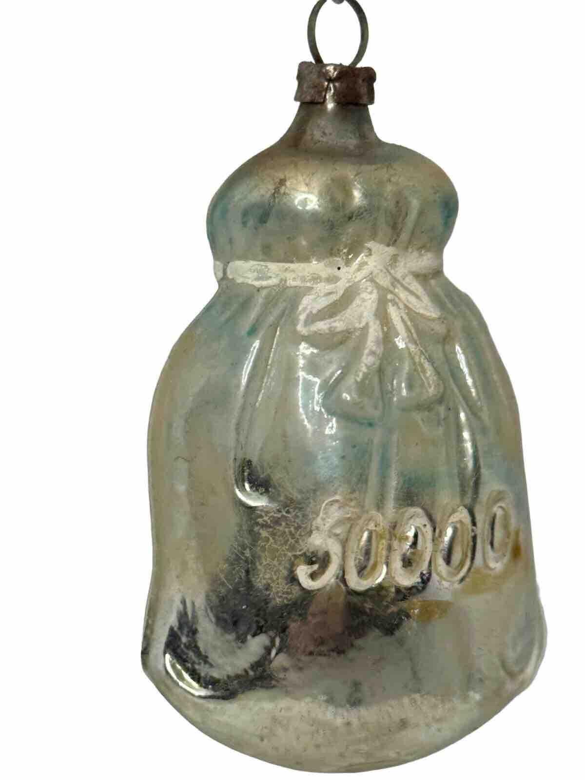 Add a touch of vintage charm to your Christmas tree with this antique German glass ornament. The unique design features a money bag, perfect for those who love to incorporate monetary elements into their holiday decor. The delicate mercury glass