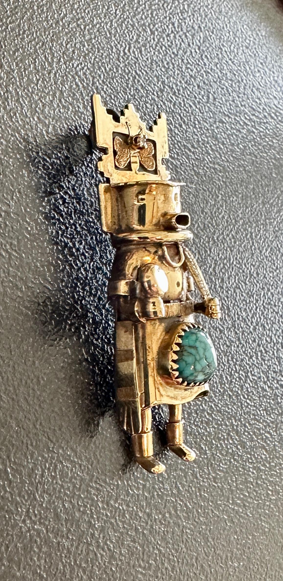 THIS IS A MAGNIFICENT AND RARE KATSINA, KACHINA PENDANT BY THE RENOWNED YAQUI NATIVE AMERICAN INDIAN ARTIST MICHAEL HORSE.   THE RARE JEWEL IS 14 KARAT YELLOW GOLD WITH A DIAMOND SET IN THE BUTTERFLY HEADDRESS AND A STUNNING TURQUOISE GEM IN THE