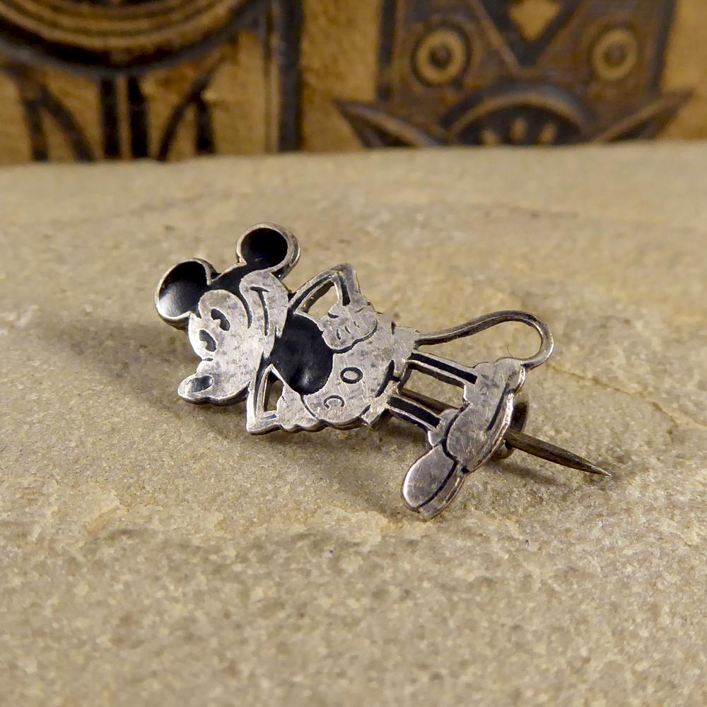 25mm tall this set of die-cut Sterling Silver and Black Enamel pins depict Mickey Mouse in his classic pose. They were from the 1930's and marked on the reverse with 