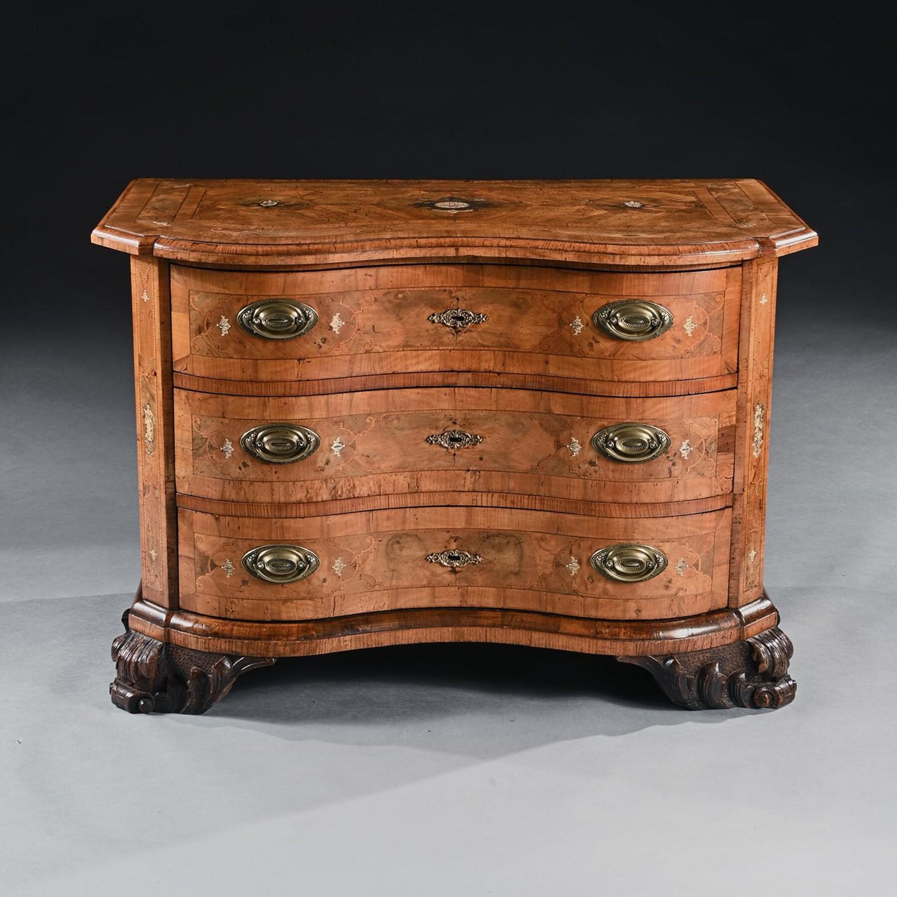 A Fine 18th Century German Walnut shaped oxbow-fronted Commode inlaid with Ivory and Pewter 

German - Probably made in Braunschweig Circa 1740

A masterful example of a fine 18th century German commode with marquetry and parquetry combining burr,