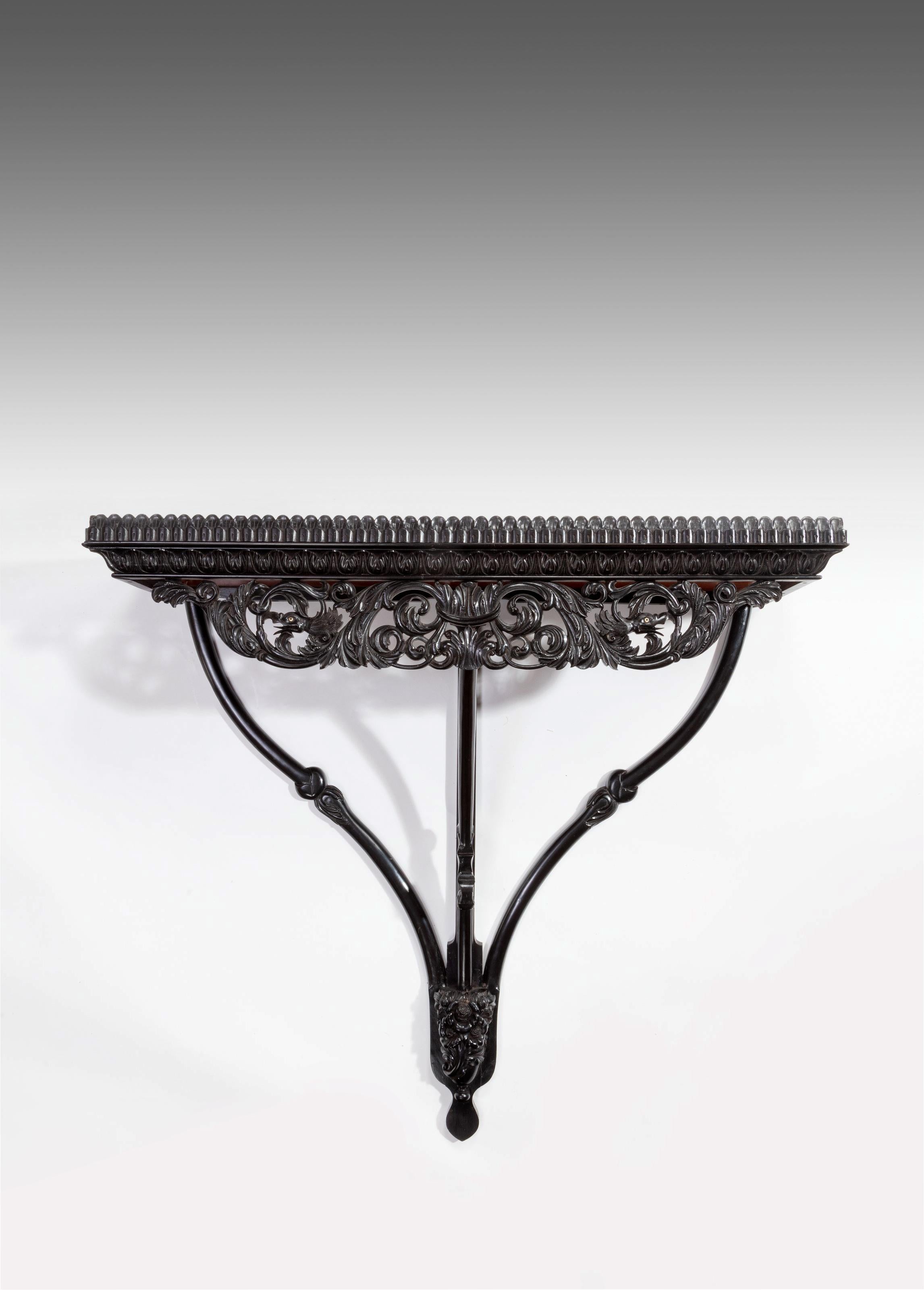A rare and finely carved Anglo-Indian - Ceylonese solid ebony and padouk wall bracket / shelve from the Galle district.

Ceylon (now Sri Lanka), circa 1830

Constructed from solid ebony, the finely carved rectangular upstand boarding an inset solid