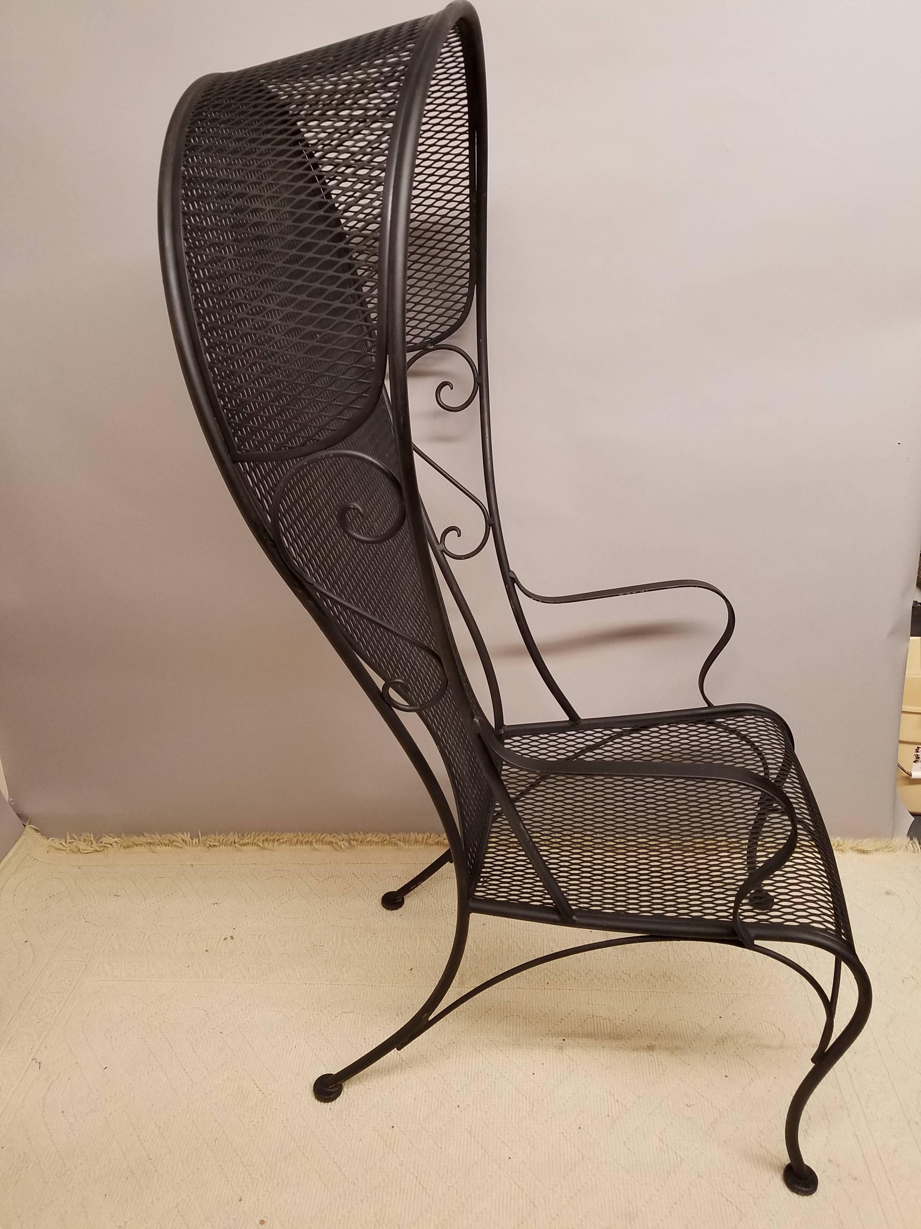 Wonderful high style and uncommon midcentury hooded iron garden chair. Flat black paint. The shapely hooded back with scrolled sides and shapely seat. Measures: Seat height is 16
