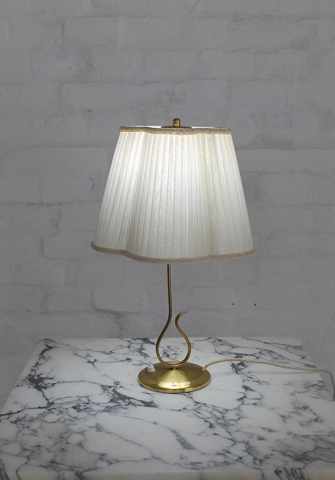 Very rare and stylish brass table lamp from the late 1940s-early 1950s.
Two tone brass base and flower shaped lampshade. 
Fantastic signed handwork, in very good condition
1 bulb E27, 1 x 100 watt maximum, 110/220 volt.
 Any type of light bulb can
