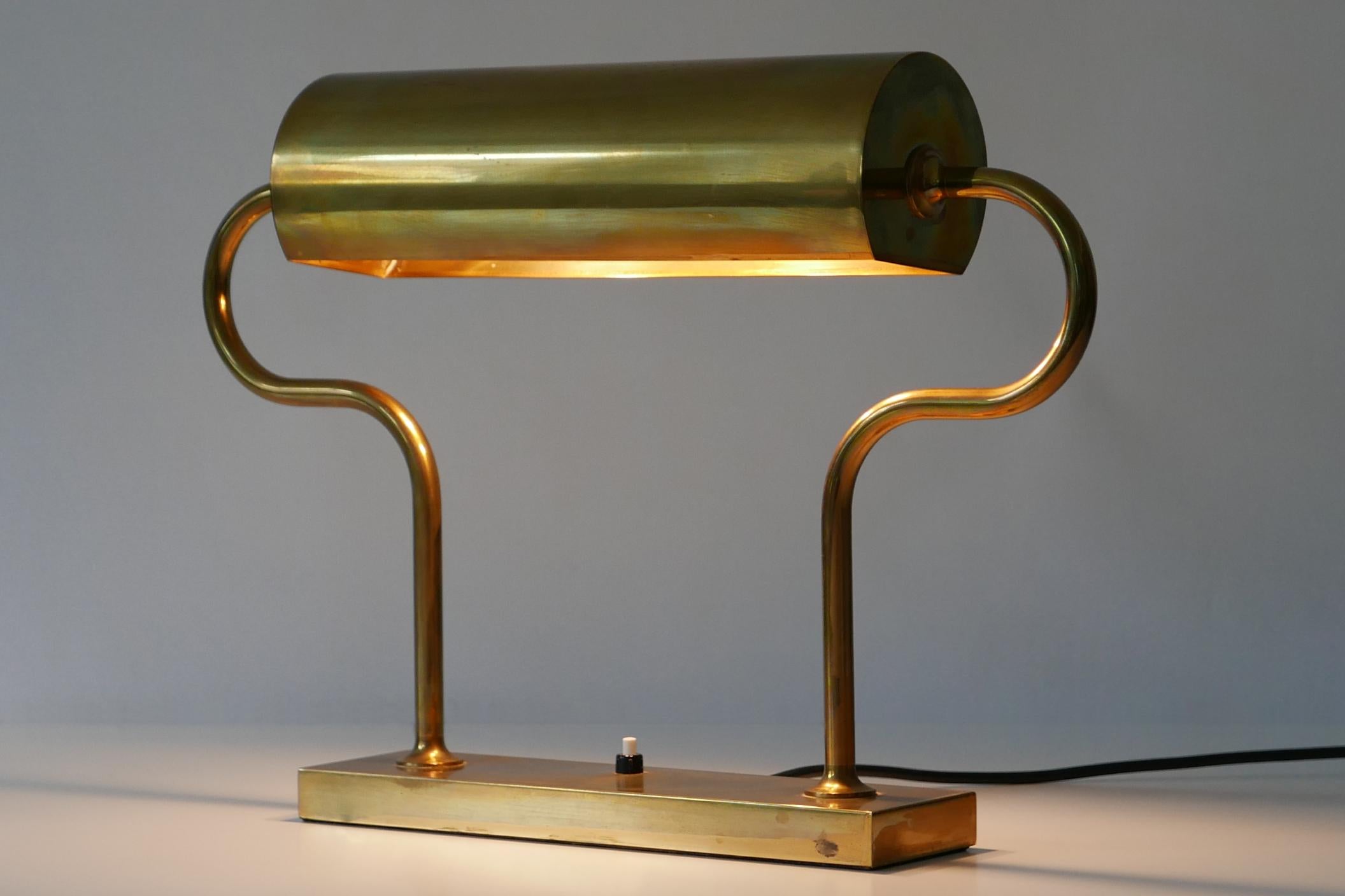 Extremely rare and elegant Mid-Century Modern brass table lamp with rotating reflector. Designed and manufactured by Florian Schulz, early 1980s, Germany. 
Florian Schulz confirmed that the lamp is produced in early 1980 in a small