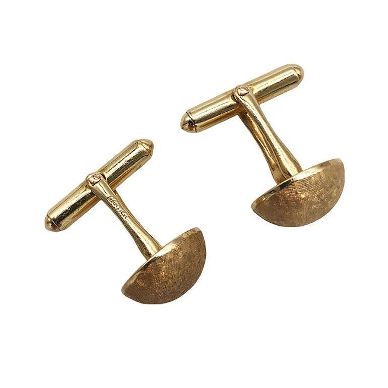 Exquisite and timeless Cartier cufflinks exude luxury with Mad Men-era styling straight out of Don Drape's Closet. Crafted in gleaming brushed gold, their classic mid-century design showcases Cartier's elegance and sophistication. A luxurious