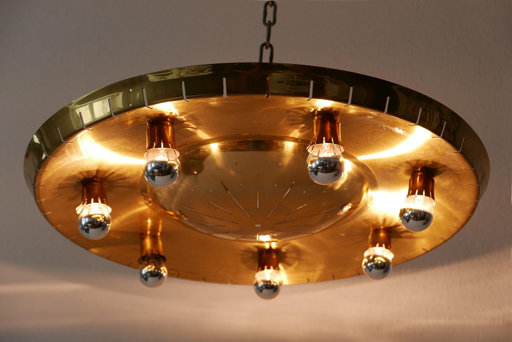 Exceptional Mid-Century Modern flush mount or ceiling fixture. Designed probably by Günter Trieschmann, 1950s, Stuttgart, Germany

Executed in brass, the ceiling fixture needs 11 x E14 Edison screw fit bulbs, is wired, and in working condition. It
