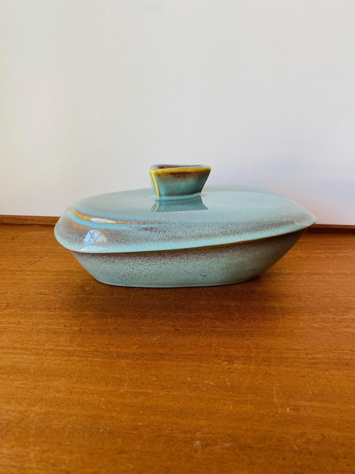 Beautiful and sculptural 1950s ceramic dish with lid.  This unique piece brings almost architectural details combined with Japanese codes of style.  A slanted profile defines the piece in union at base and lid.  Both the lid and base share an almost