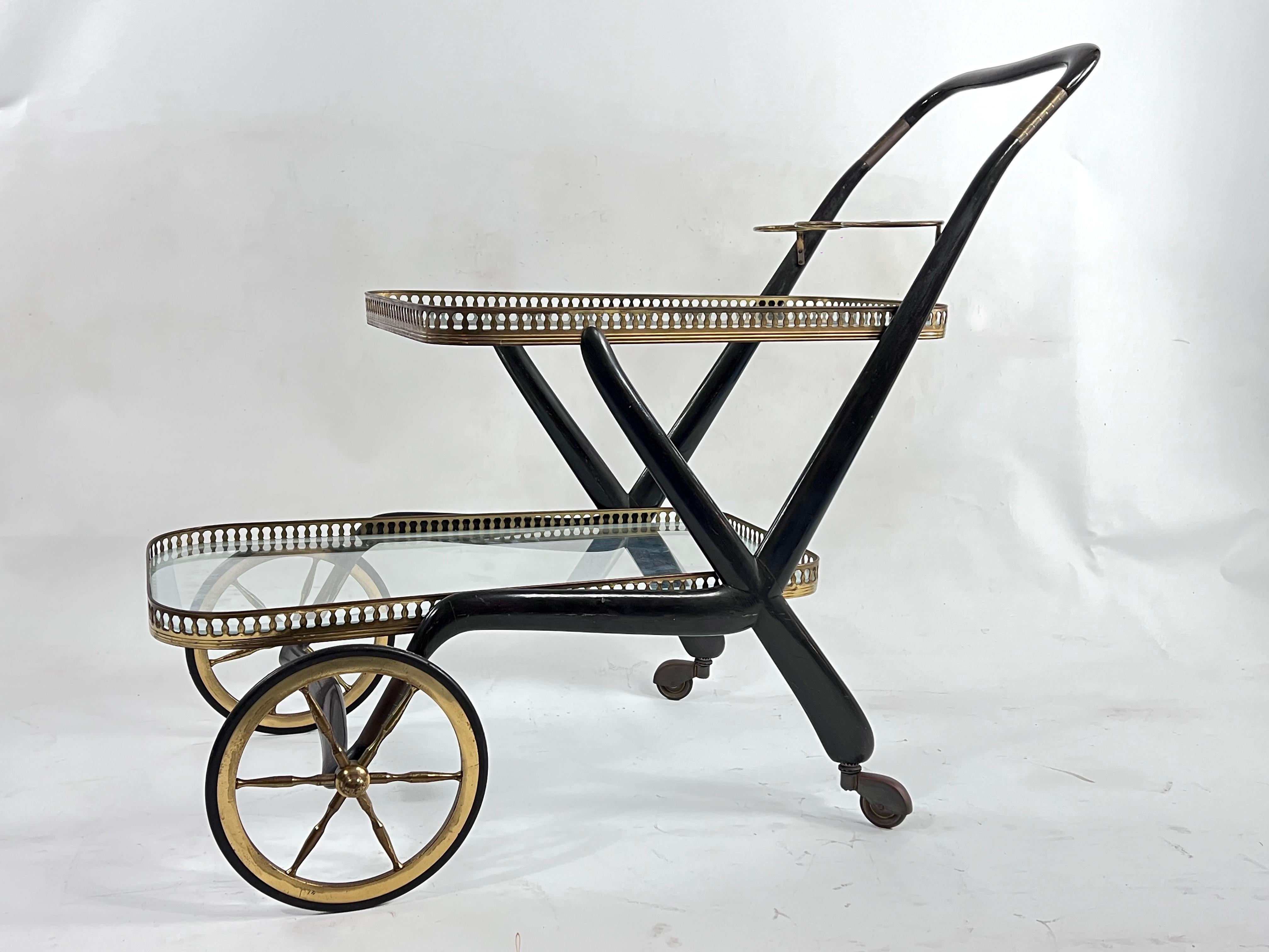 Original vintage condition with normal trace of age and use with patina on the brass for this Italian bar cart designed by Cesare Lacca and produced during the 50s. Glasses with no cracks or chips.
 