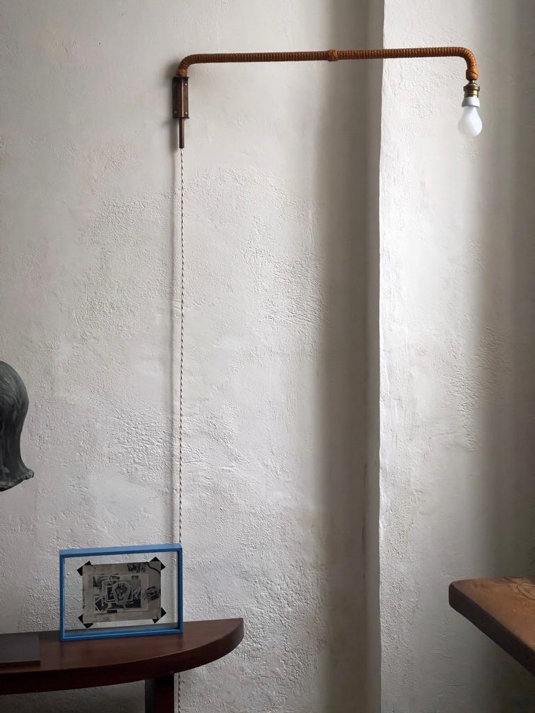 This rare mid-century French wall light is a remarkable piece, exemplifying the innovative design ethos that emerged in France during the mid-20th century. Crafted from patinated rope, brass, and copper, it seamlessly blends organic and industrial