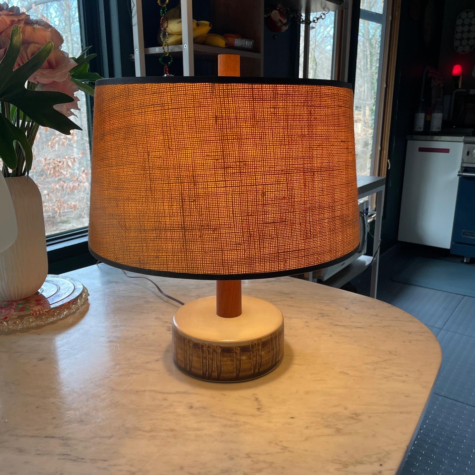 Uncommon form. Lamp body is undamaged, the older lampshade is not original and slightly dingy.  The lamp socket also retains the Marshall Studios paper label.

Dia 18.5 x H 14 .5 in.
