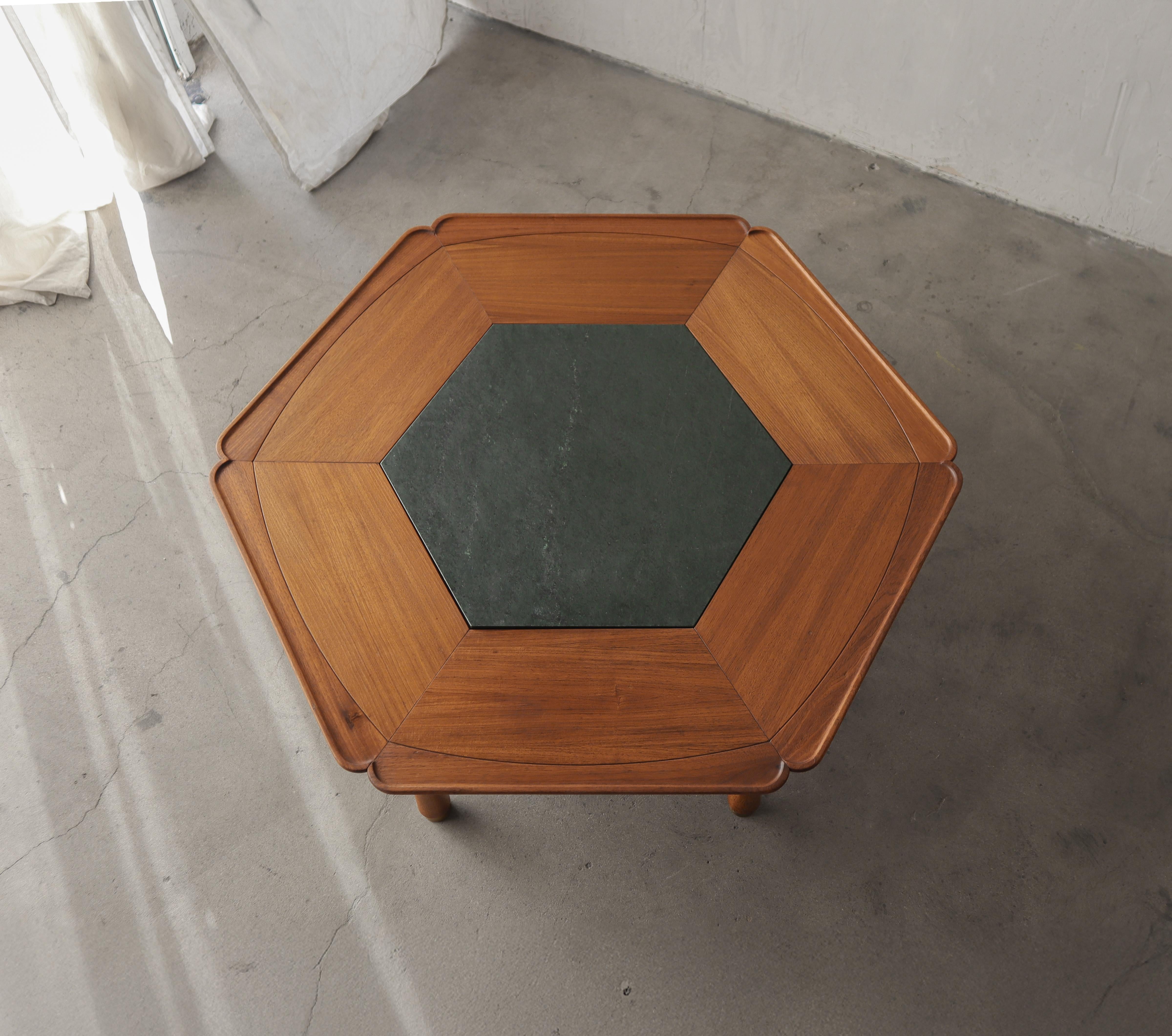 Super RARE and early Mid Century hexagonal coffee table by Heritage.   This coffee table is nothing short of incredible with the most beautiful details.  The scalloped edge, the warm honey color, centered with a gorgeous green marble center and