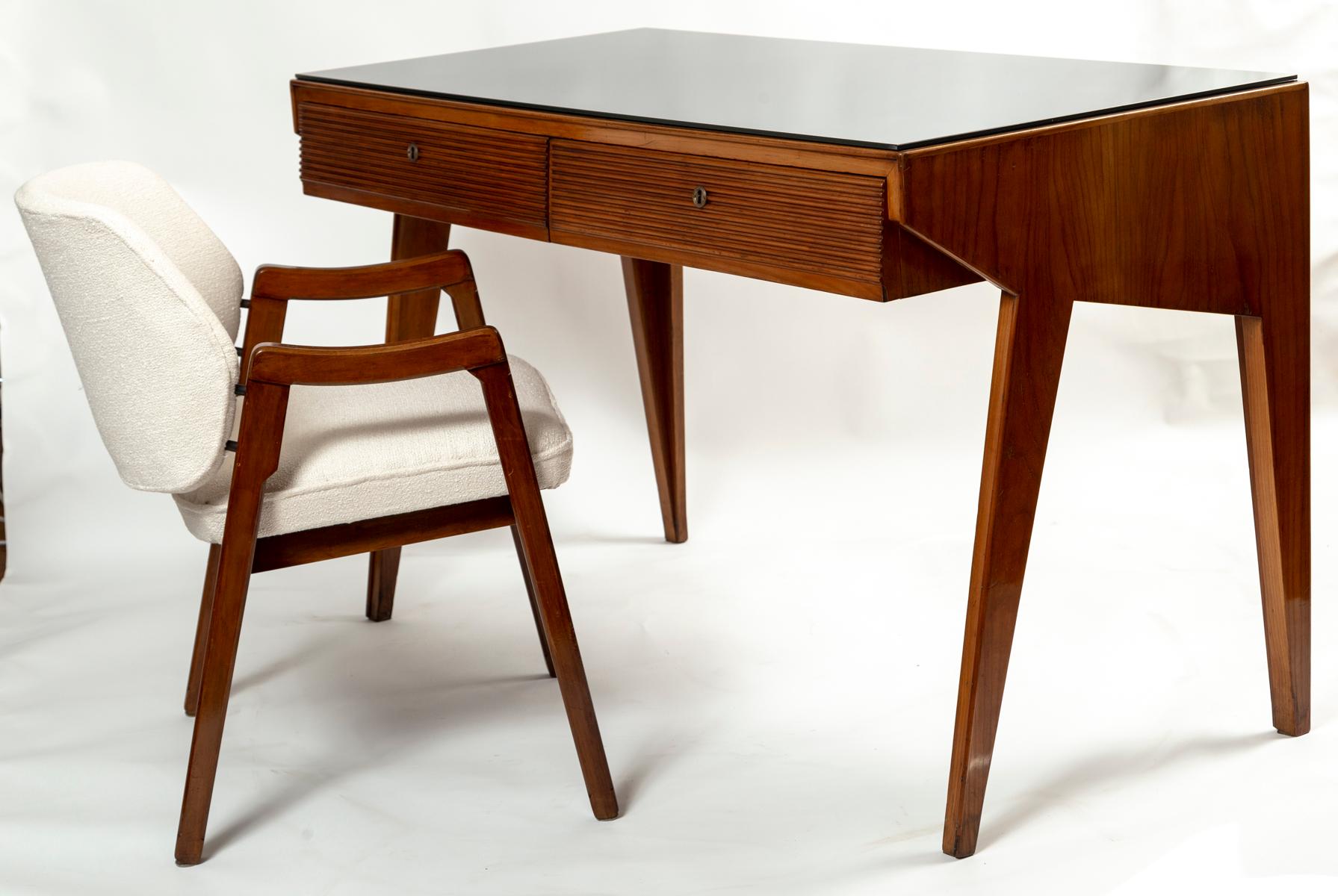 Wonderful Modernist fruitwood desk shown with its original grey laminate top which we have covered in a new black glass top above an angular base consisting of two grissinato drawers and finishing  on angled legs, note desk is not only finished on