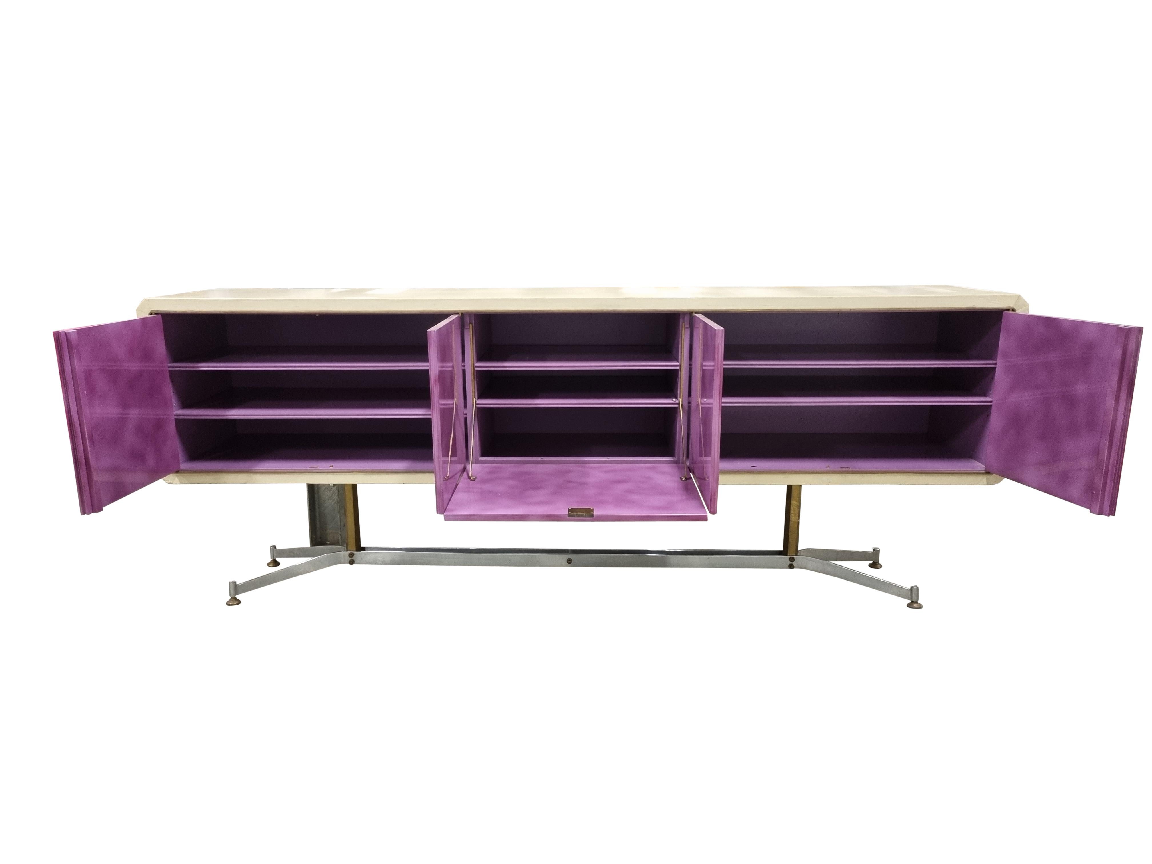 Unique mid-century sideboard designed by Enzo Missoni for a villa in the south of France.

This sideboard has the complete 1960s vibe and is a true eye catcher.

It features a chromed steel base, leather casing and purple lacquered doors.

4