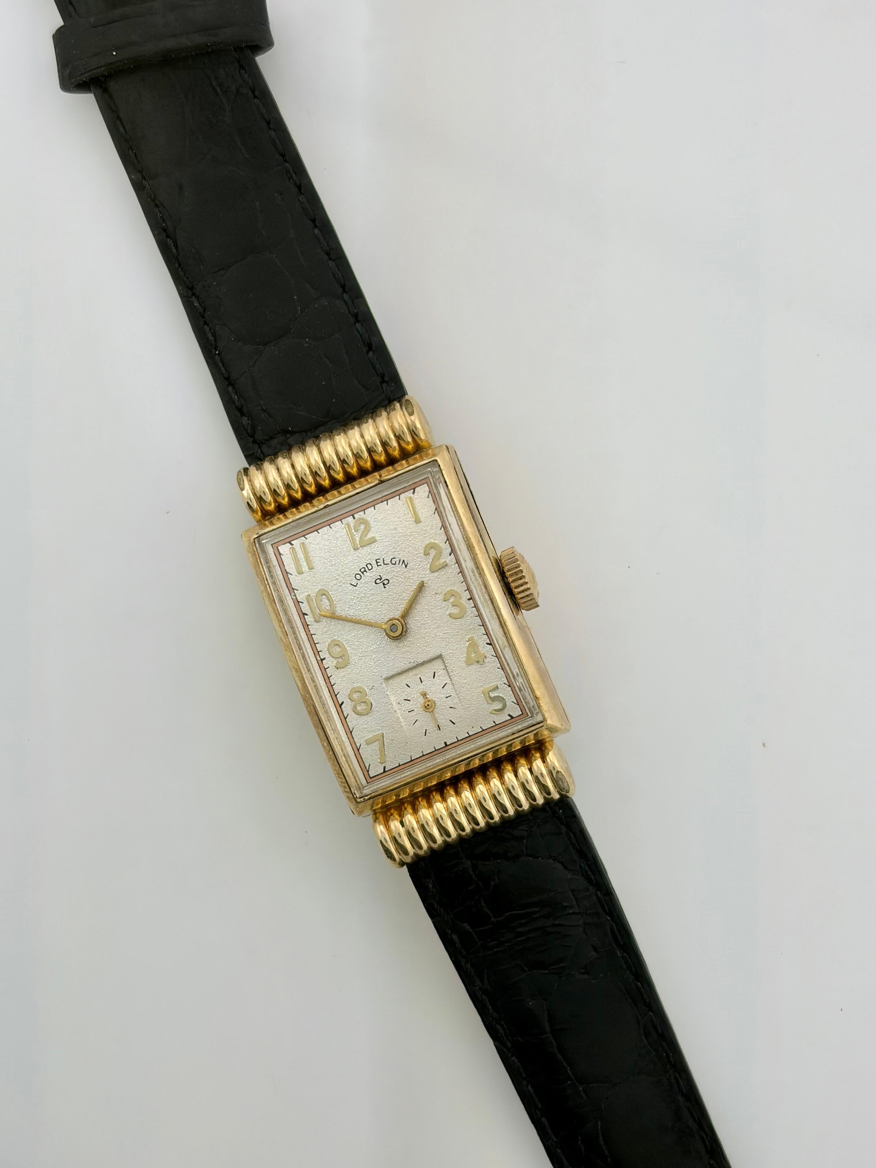 Raro Lord Elgin di metà secolo: orologio da polso in oro 14 carati, anse smerlate con cappuccio in vendita