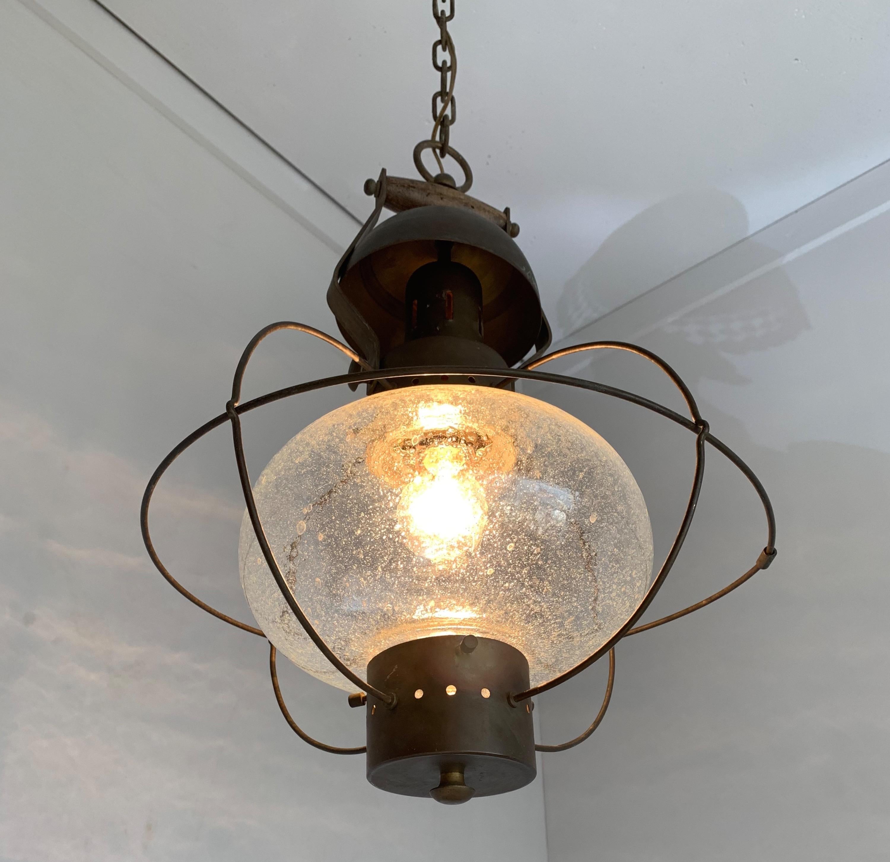 Great looking, 1950s design pendant.

If you are looking for a stylish and handcrafted midcentury chandelier then this rare design could be flying your way soon. The mouthblown glass shade inside the beautifully shaped and patinated brass frame is