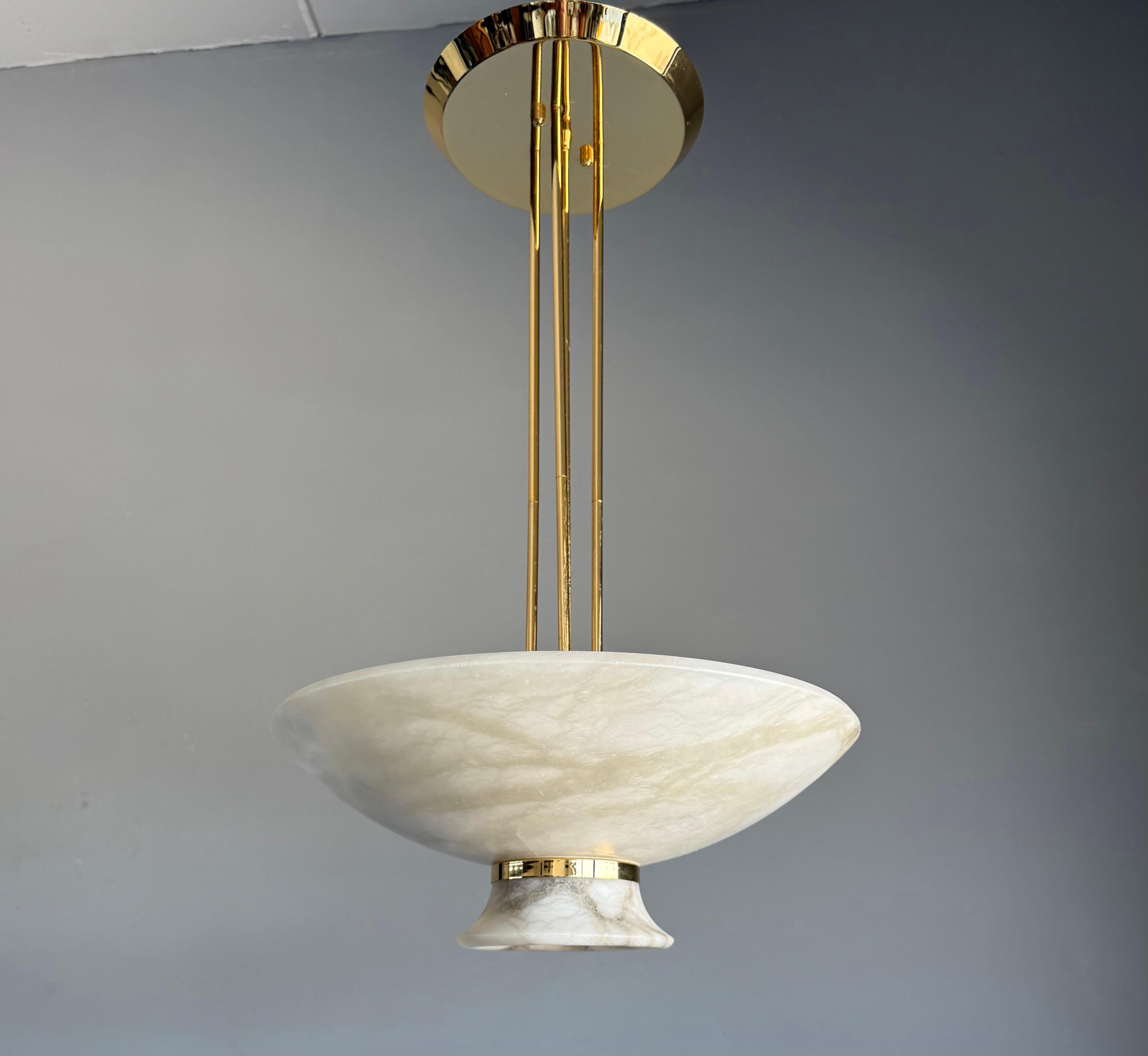 Unique alabaster flush mount / pendant light, Art Deco style.

An exquisite and rare Mid-Century Modern alabaster pendant light from the 1970s, handcrafted in Italy. This sculptural ceiling fixture features a wide alabaster bowl with warm natural