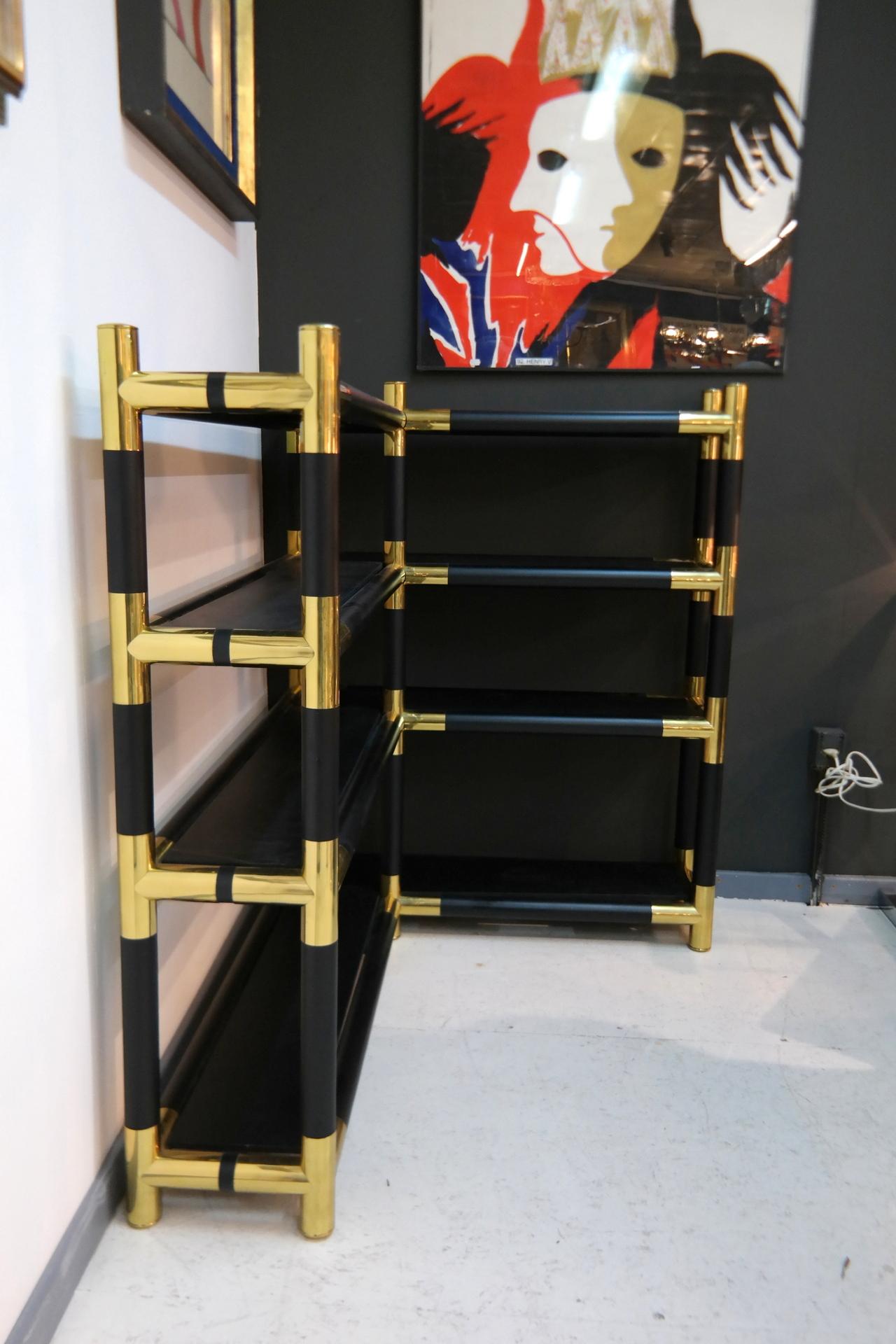 This corner bookshelf features glass wooden and massive brass joints. It's a rare Mid-Century Modern piece from the 1970s.
    