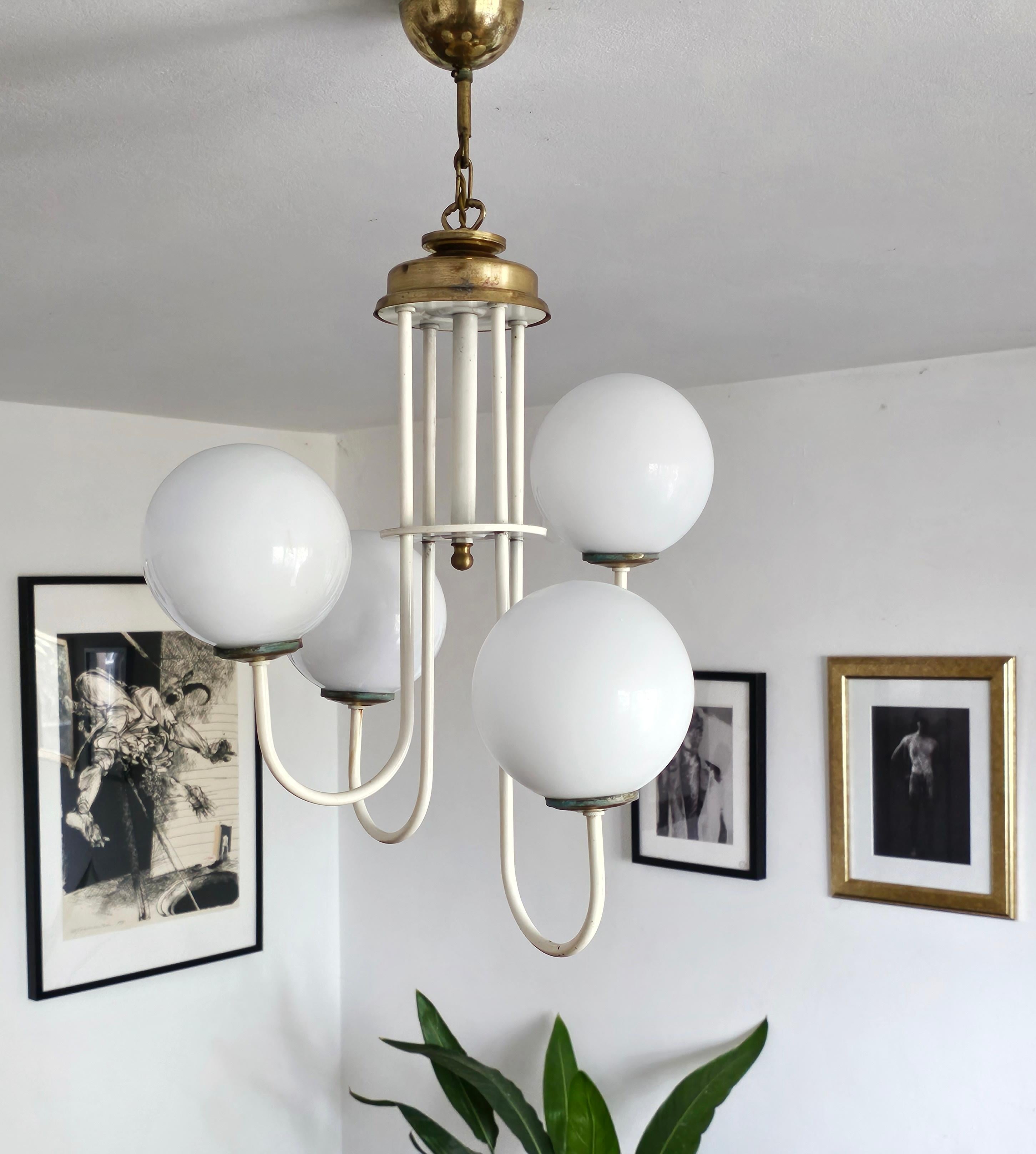In this listing you will find a beautiful and elegant Mid Century Modern Chandelier done in white painted steel, with 4 opaline glass balls. Simple, yet beautiful design will stand out in any space this gorgeous piece is place into. Made in Italy in