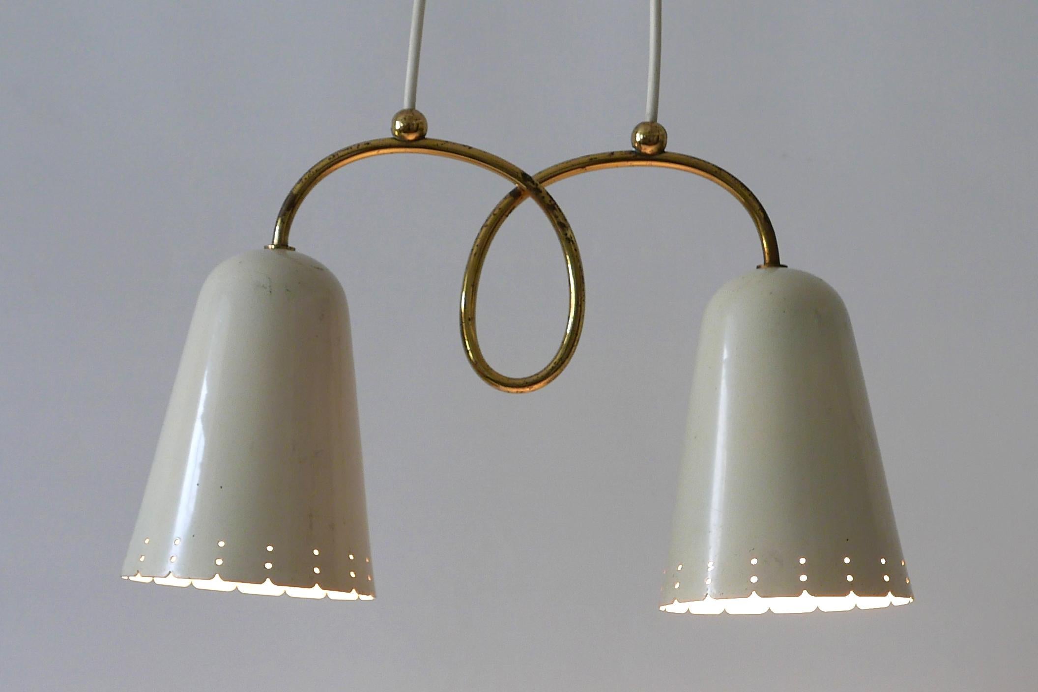 Extremely rare and elegant Mid-Century Modern pendant lamp or hanging light with two perforated shades. Manufactured probably in 1950s in Germany.

Executed in beige enameled and perforated aluminum and brass, it needs 2 x E27 / E26 Edison screw