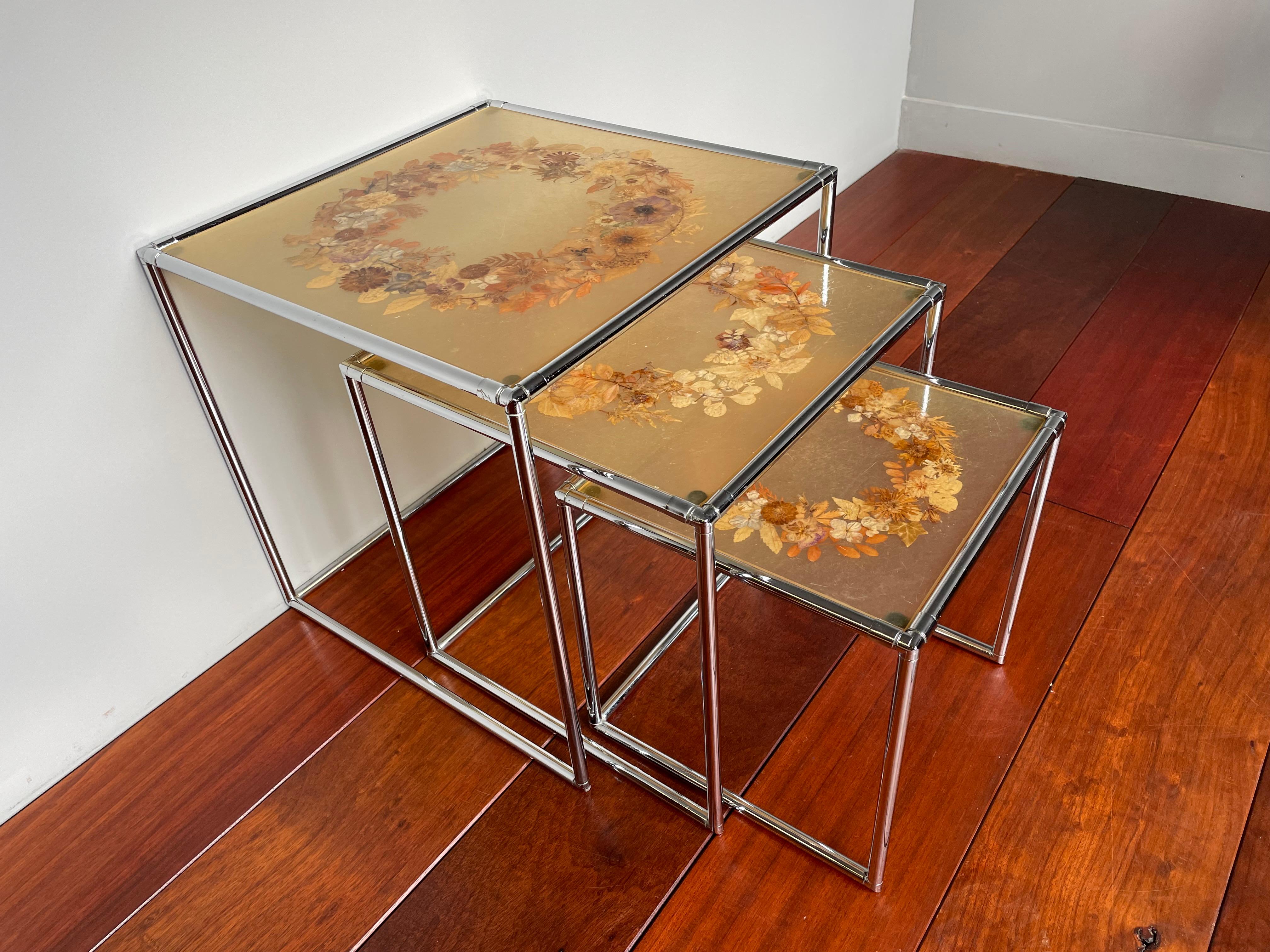 Beautiful design and great colors nest of tables with resin tops with real flowers and leafs inclusions.

These striking nesting tables with removable tops are all handcrafted with a unique technique of real flowers and leaf inclusions. We have
