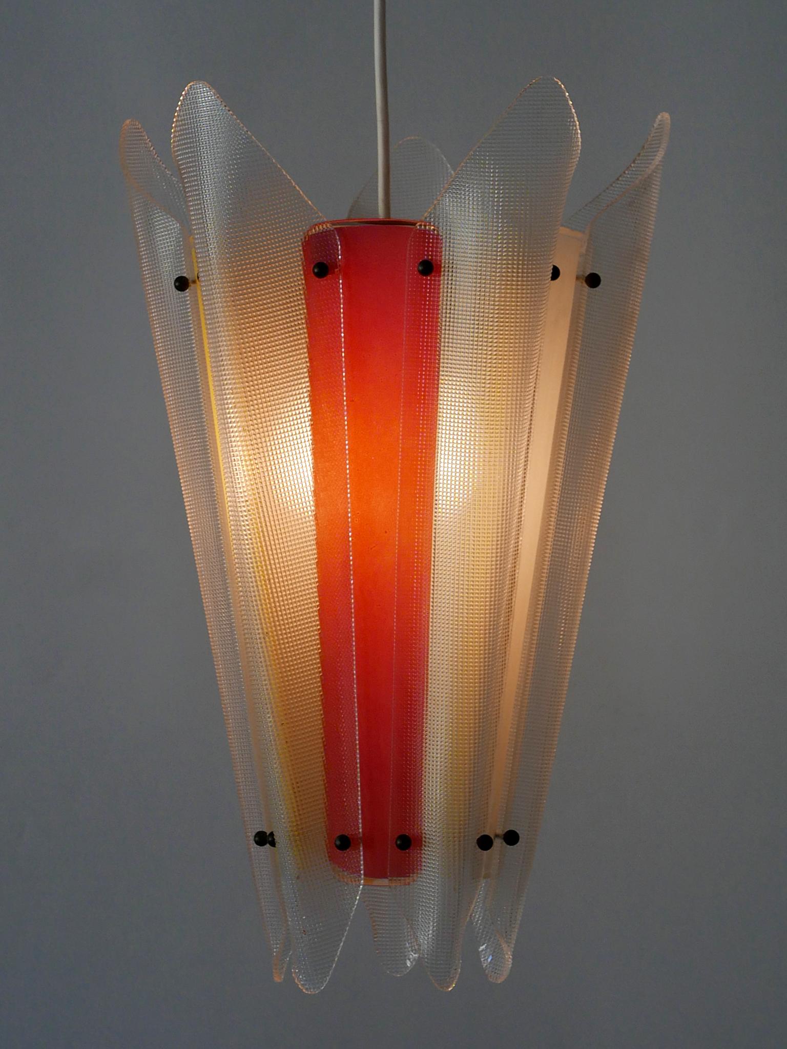 Extremely rare and highly decorative Mid-Century Modern multi-colored pendant lamp or hanging light. Designed and manufactured in Germany, 1960s.

Executed in multi-colored lucite, the lamp needs 1 x E27 / E26 Edison screw fit bulb. It is rewired,