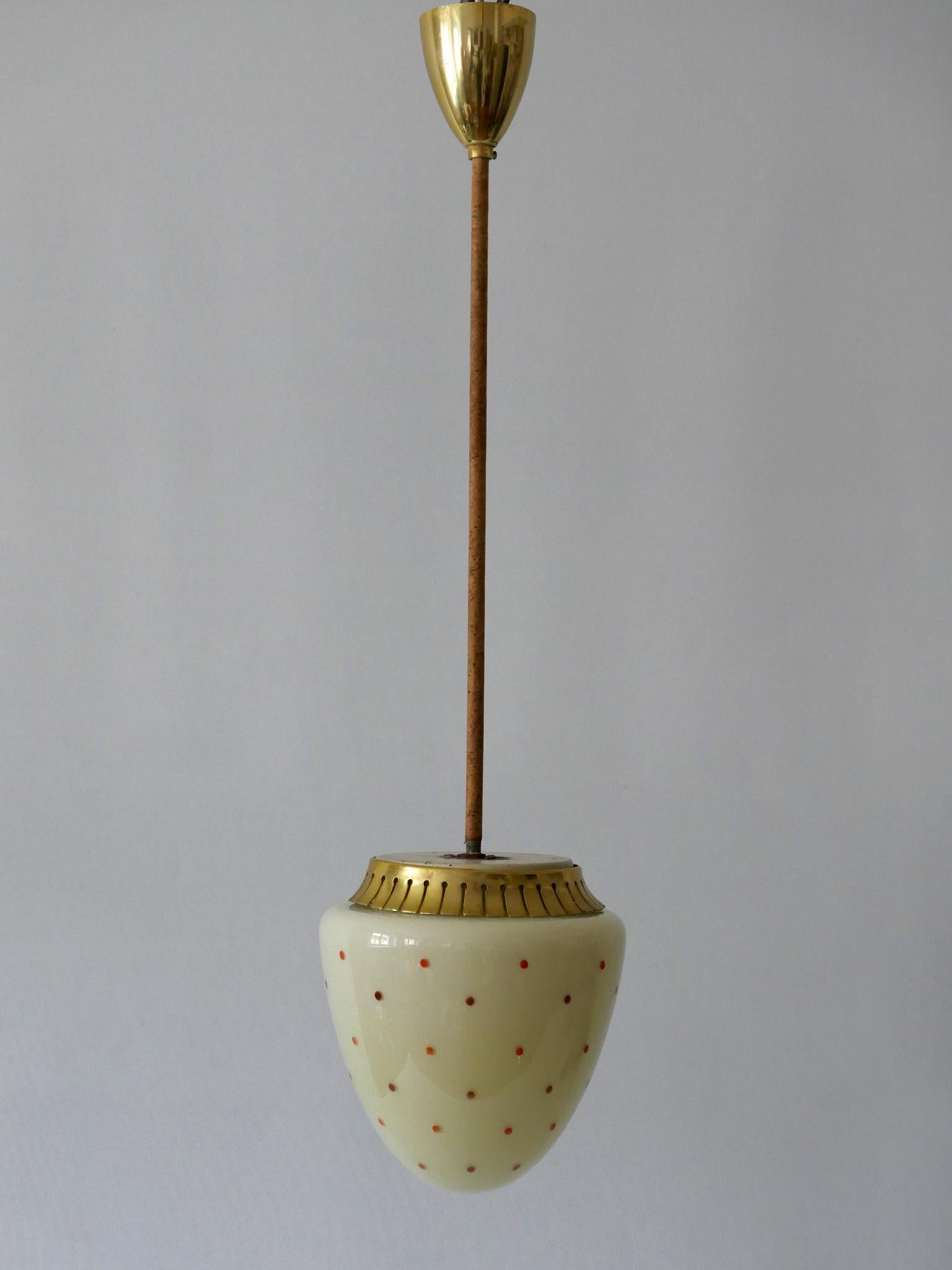 Exceptional and elegant Mid-Century Modern pendant lamp. Designed and manufactured in 1950s, Germany

Executed in crème-colored opaline glass, brass anodized aluminium, and metal, the pendant lamp needs 1 x E27 / E26 screw fit bulb, is wired, in