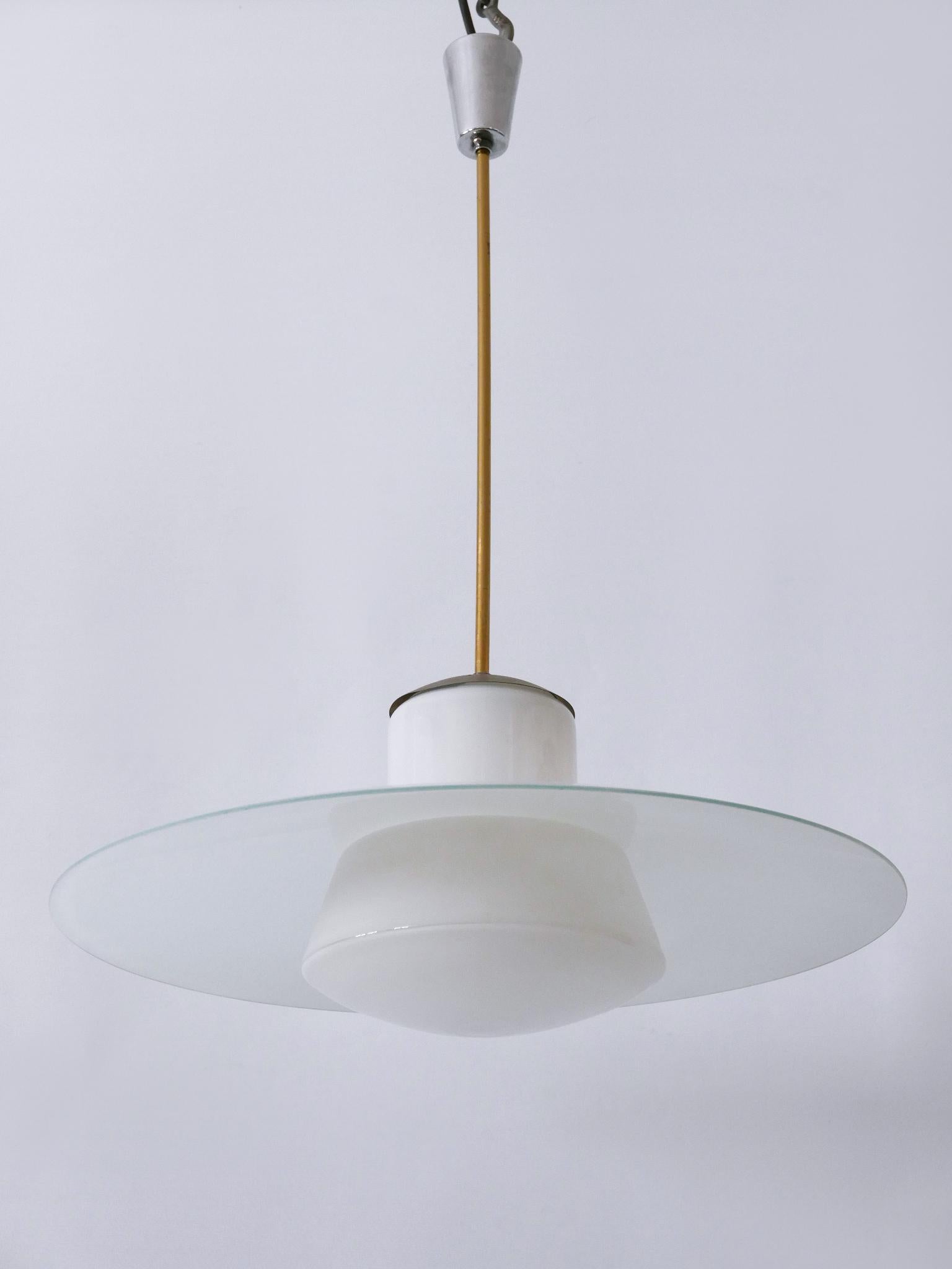 Extremely rare and elegant Mid-Century Modern pendant lamp or hanging light. Catalog no 913/3522 - 55. Designed by Wolfgang Tümpel for Doria Leuchten, Germany, 1950s.

Executed in opaline glass and chrome-plated brass, the pendant lamp needs 1 x E27