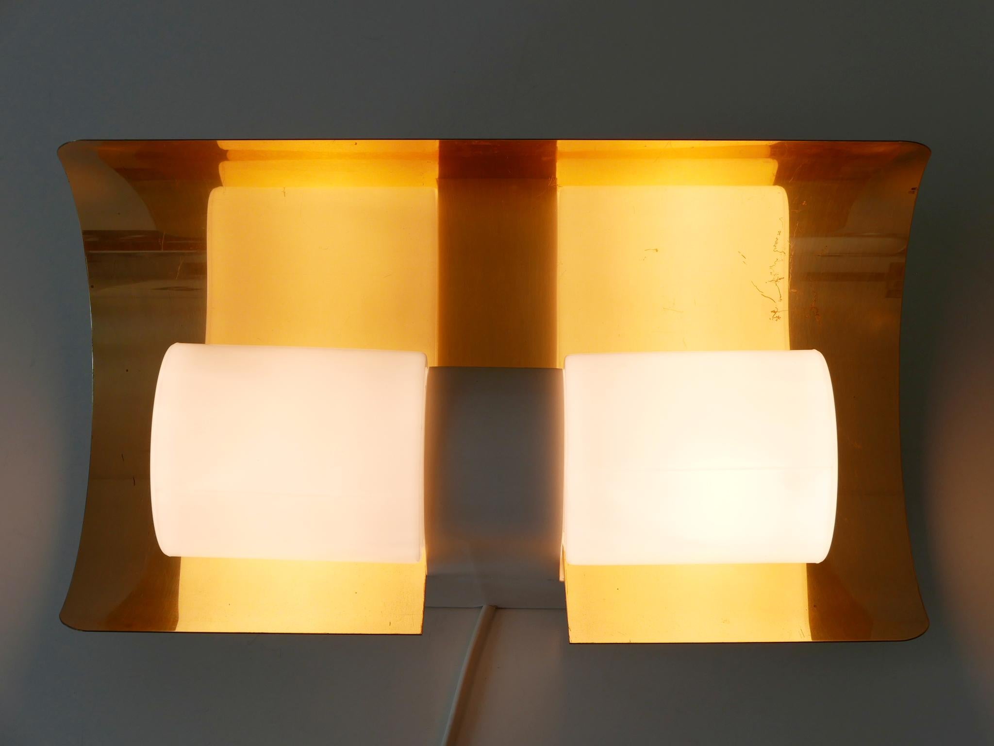 Rare, elegant and highly decorative Mid-Century Modern sconce or wall fixture. Designed by Hans-Agne Jakobsson for AB Markaryd, Sweden, 1950s. Marked with makers label revers.

Executed in brass, opaline glass and plastic, the sconce is executed