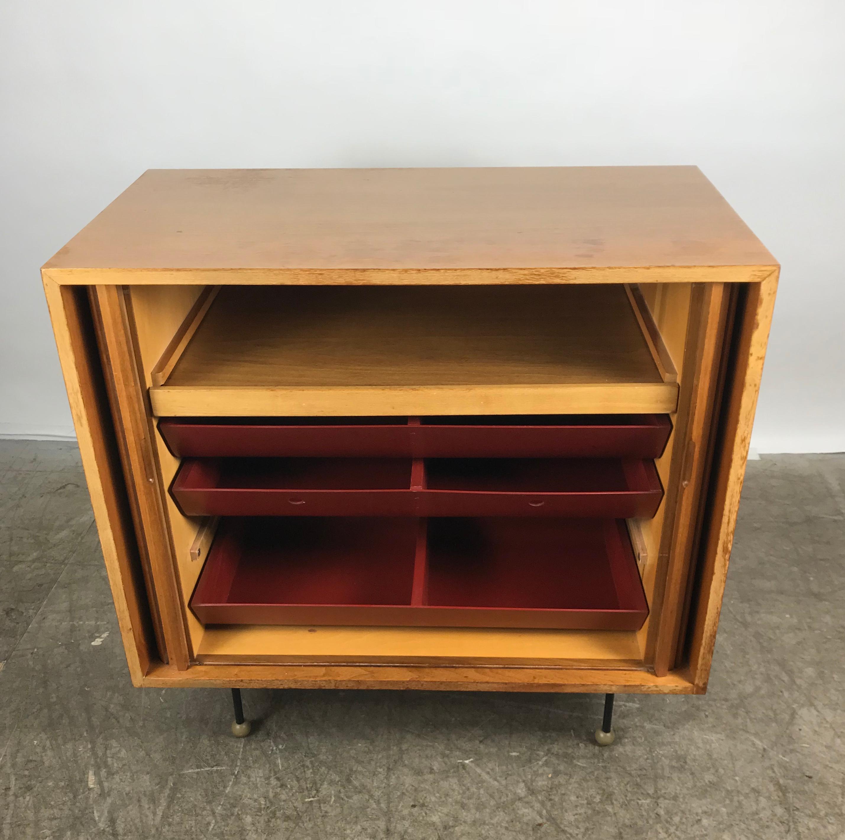 Rare Mid-Century Modern Tambor door cabinet by Greta Grossman, nice original condition. Features two tambor doors over pullout / pull-out shelf and three wood and fiberglass divided drawers, and of course signature iron stick legs with wonderfully