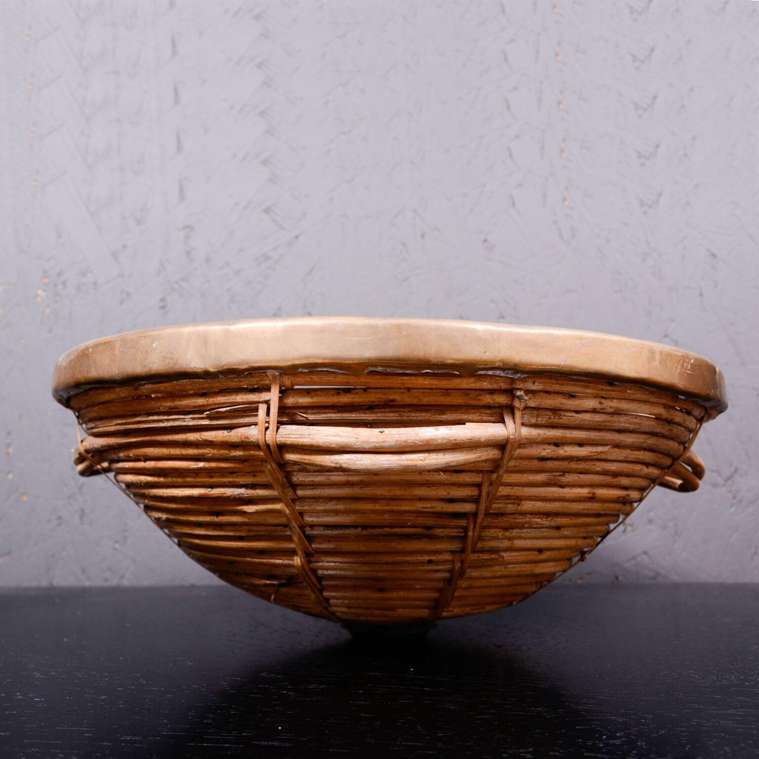 a beautiful Mid Century Modern Woven Basket with Brass Accents. 
Unique design with handles.
Designed attribution Arthur Umanoff. 
No labels present. 1960s.
16 1/2