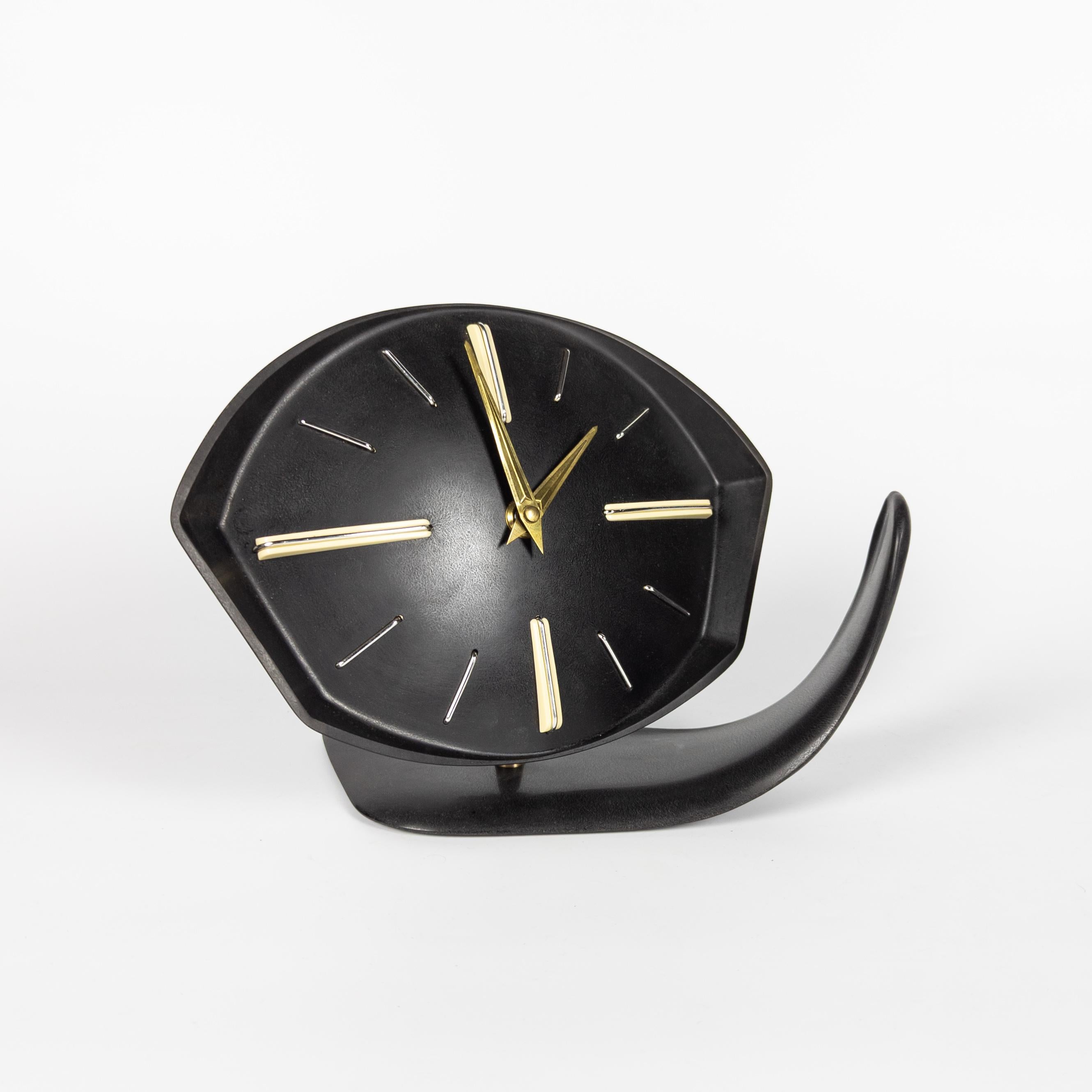 Extremely rare clock from Czech manufacturer PRIM. Manufactured in former Czechoslovakia in 1950's. Black bakelite body with brass hands. The clock is hinged and can be placed in several positions. It can be placed on the table or hanged on the